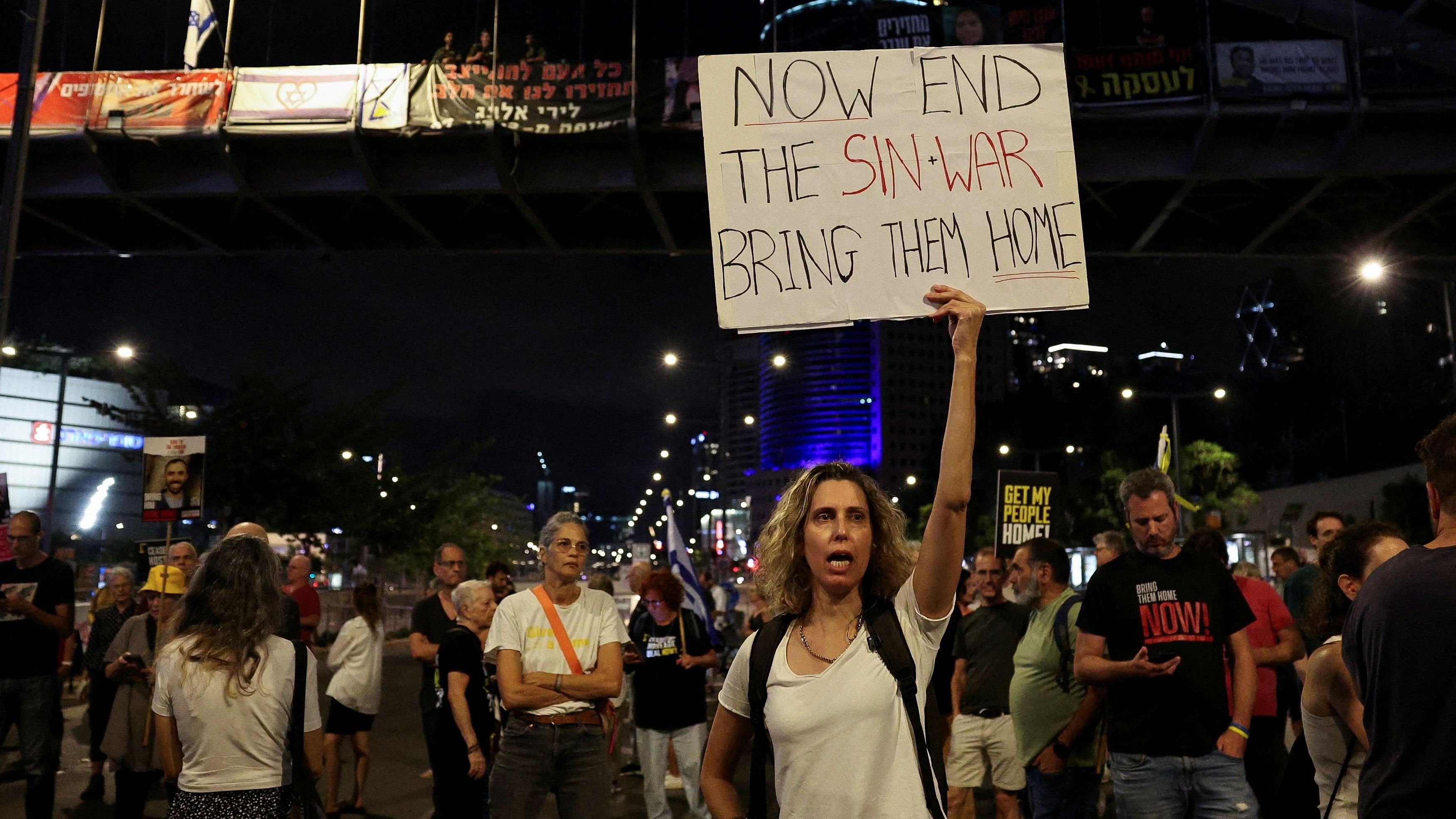 <div class="paragraphs"><p>A demonstrator holds a sign with a reference to Hamas leader Yahya Sinwar, after Israeli military said they have killed him, as families and supporters of hostages kidnapped during the deadly October 7, 2023 attack, protest against the government and to demand their immediate release, amid the ongoing conflict in Gaza between Israel and Hamas, in Tel Aviv, Israel.</p></div>