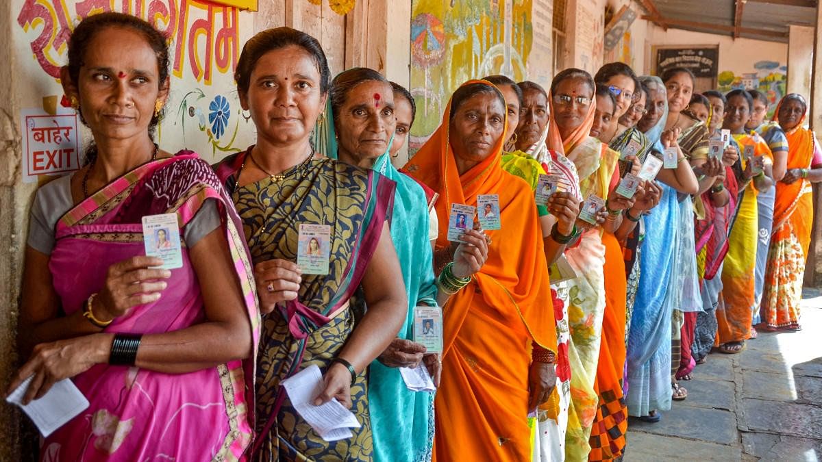 <div class="paragraphs"><p>Woman voters display their identity cards.</p></div>