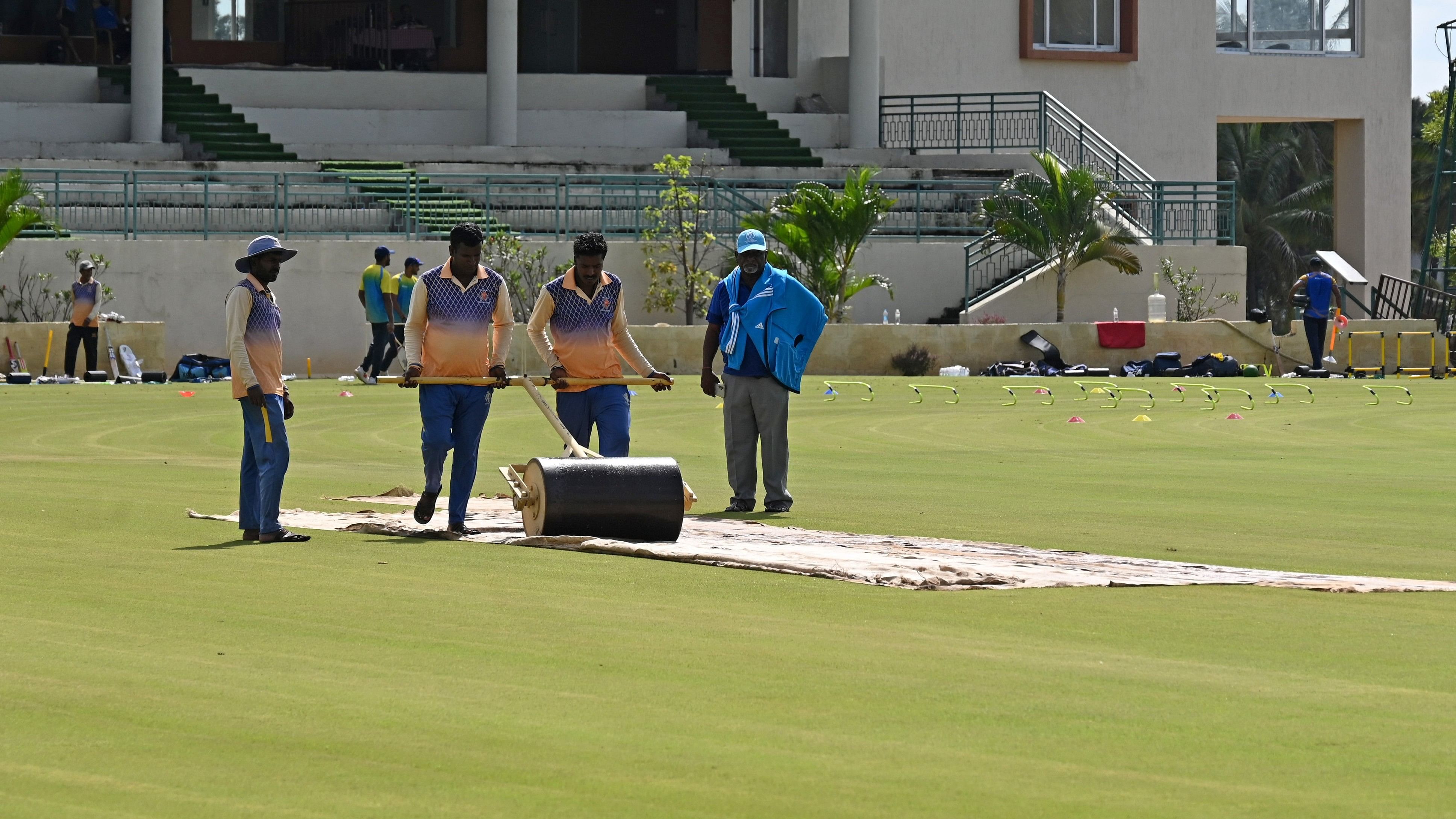 <div class="paragraphs"><p>Ground staff at Alur 1 ground try to dry a wet patch that delayed the start of the Ranji Trophy game between Karnataka and Kerala.&nbsp;</p></div>