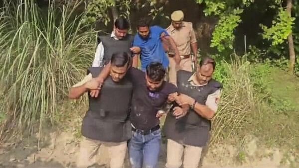 <div class="paragraphs"><p>Police personnel take away suspects in the Bahraich violence case after they were arrested following an encounter with them, in Bahraich district, Thursday, October 17, 2024. The accused were allegedly trying to flee to Nepal, which shares a border with Bahraich district.</p></div>