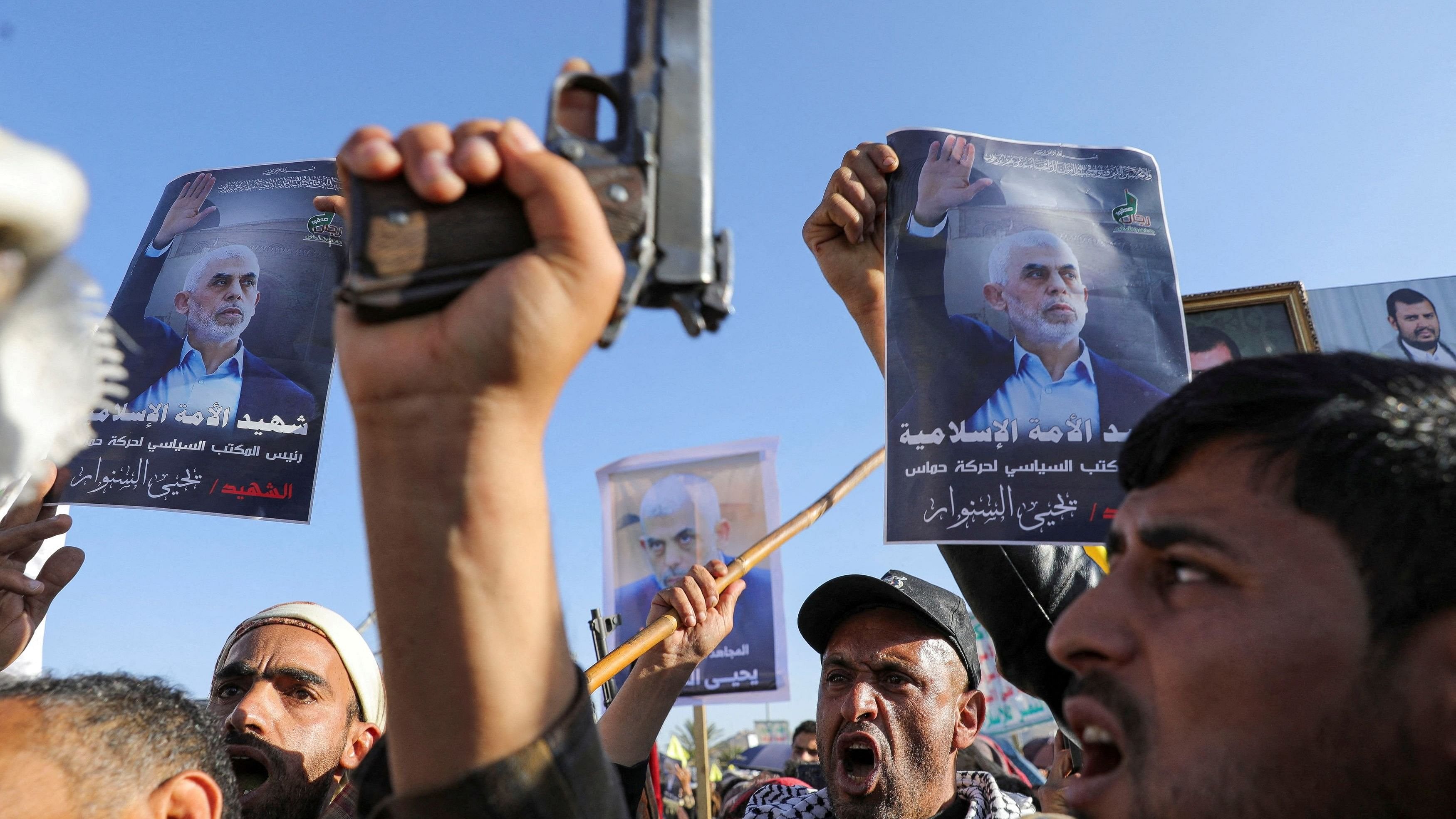 <div class="paragraphs"><p>Protesters, mainly Houthi supporters, hold posters showing the late Hamas leader Yahya Sinwar as they rally to show support to Lebanon's Hezbollah and Palestinians in the Gaza Strip, in Sanaa, Yemen.</p></div>