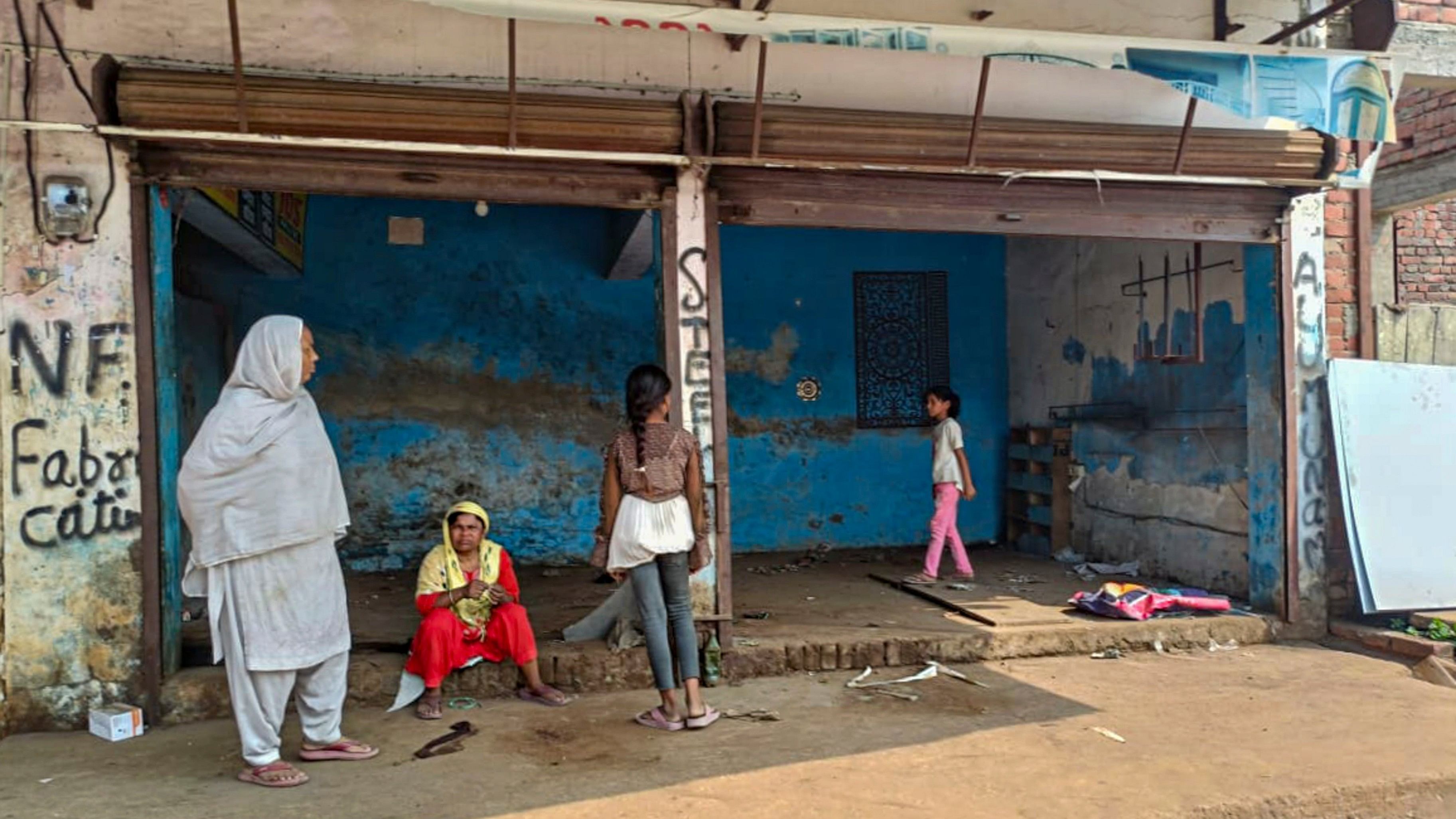 <div class="paragraphs"><p>Locals outside an empty shop after public works department (PWD) pasted notices on the properties of several people asking them to remove any illegal construction and warning of action, in violence-hit Maharajganj area of Bahraich, UP, Saturday, Oct 19, 2024. </p></div>