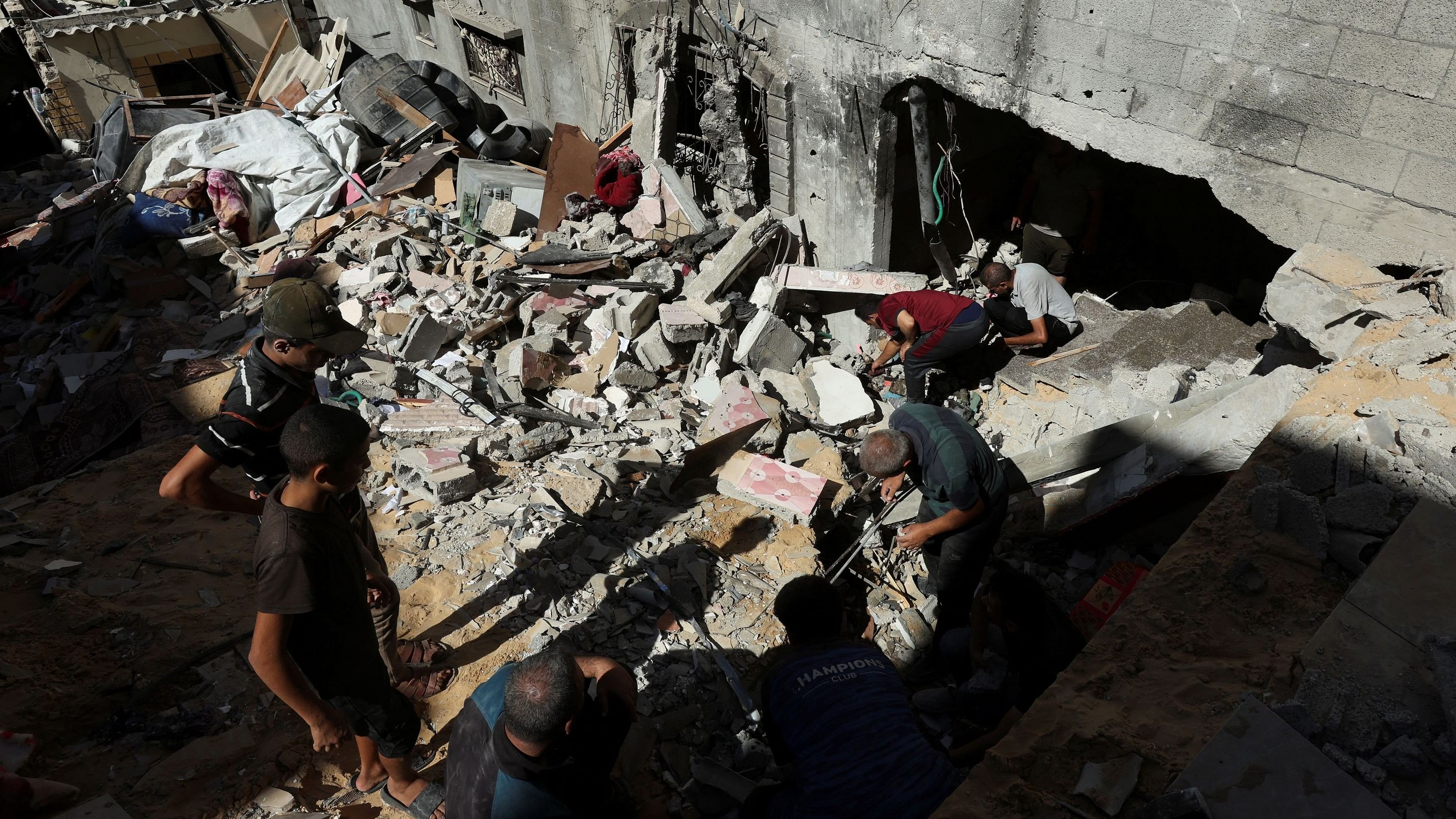 <div class="paragraphs"><p>Palestinians inspect the site of an Israeli strike on a house, amid the ongoing Israel-Hamas conflict, in Al Maghazi refugee camp in the central Gaza Strip, October 19, 2024. </p></div>