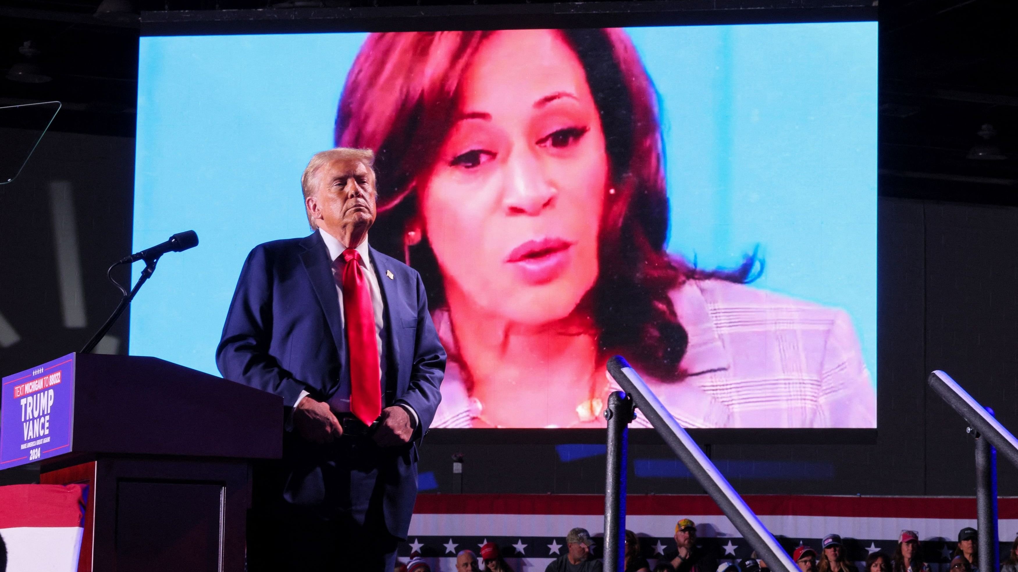 <div class="paragraphs"><p>Republican presidential nominee and former US President Donald Trump looks on as Democratic presidential nominee and US Vice President Kamala Harris' face appears as a video plays on a screen, during a rally. Representative image.</p></div>