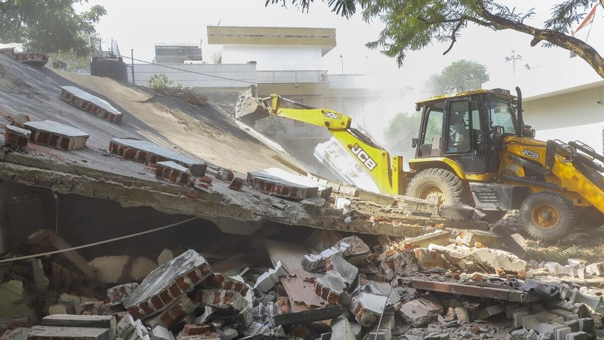 <div class="paragraphs"><p>A bulldozer being used to demolish the illegal construction belonging to Naseeb Choudhary, who is accused of knife attack on RSS members, in Jaipur, Sunday, Oct 20, 2024. Few RSS members were allegedly attacked during a religious event at a temple in Jaipur. </p></div>