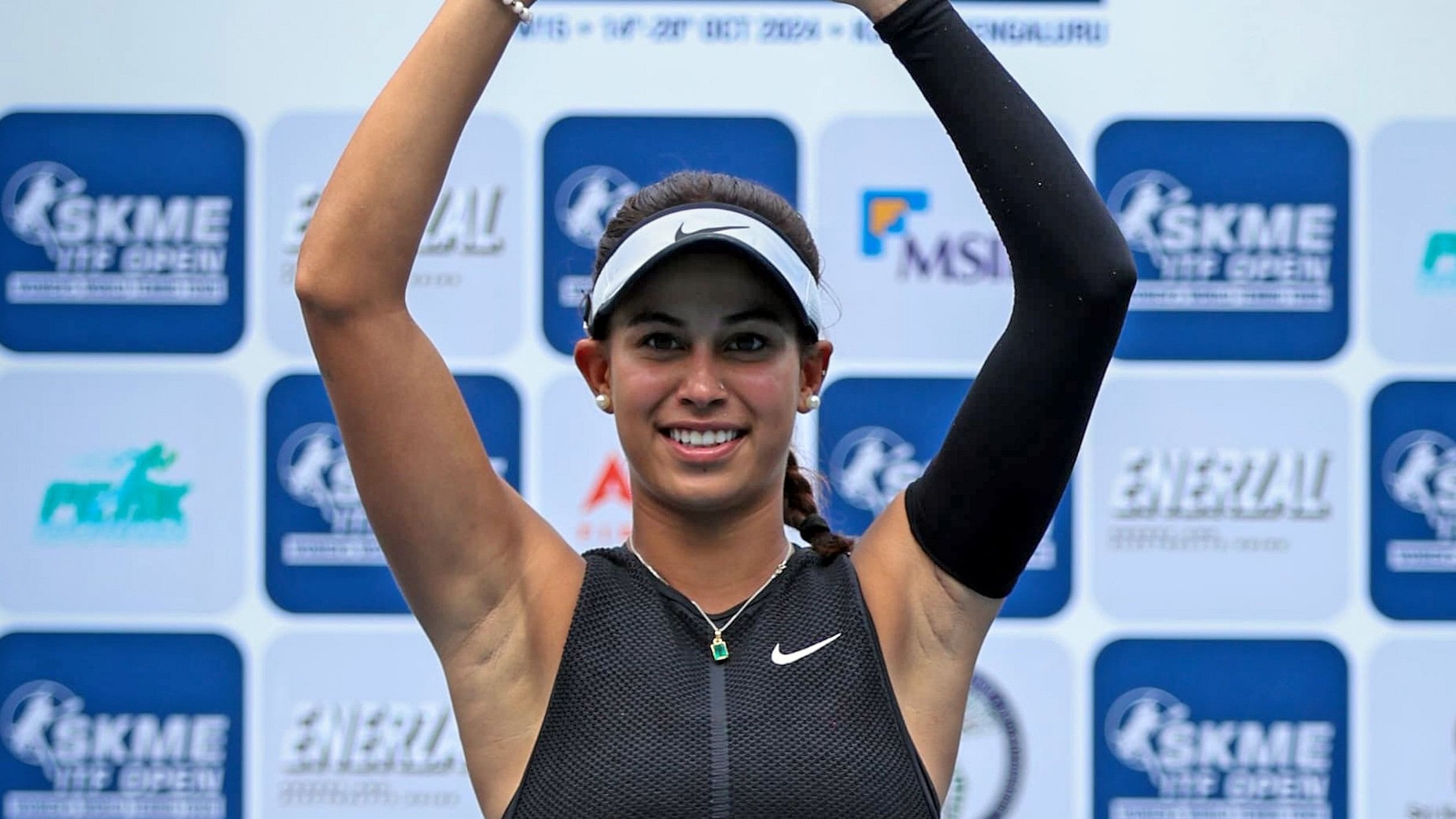 <div class="paragraphs"><p>Winner Tanisha Kashyap poses with the&nbsp;SKME ITF Open trophy at the KSLTA tennis stadium in Bengaluru on Sunday.</p></div>