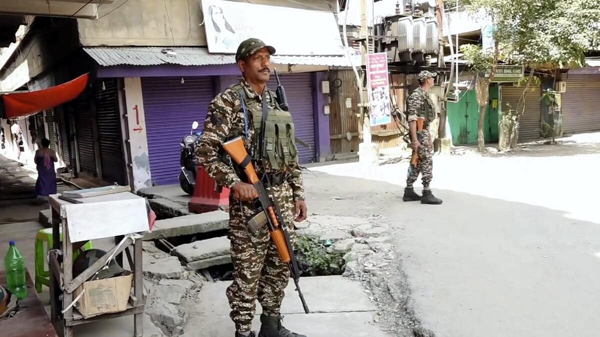 <div class="paragraphs"><p>Security personnel stand guard  in Manipur.</p></div>