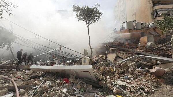 <div class="paragraphs"><p>Civil defence members put out a fire at a damaged site, in the aftermath of Israeli strikes on Beirut's southern suburbs, Lebanon.&nbsp;</p></div>