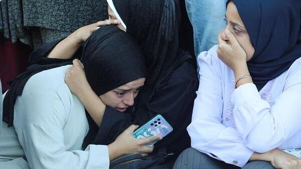 <div class="paragraphs"><p>Mourners react near the bodies of Palestinians, who were killed in an Israeli strike, at Al-Aqsa Martyrs Hospital in Deir Al-Balah.</p></div>