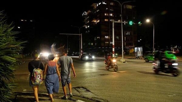 <div class="paragraphs"><p>People walk along a street as Cuba's government said on Saturday it had made some progress in gradually re-establishing electrical service across the island, in Havana.&nbsp;</p></div>