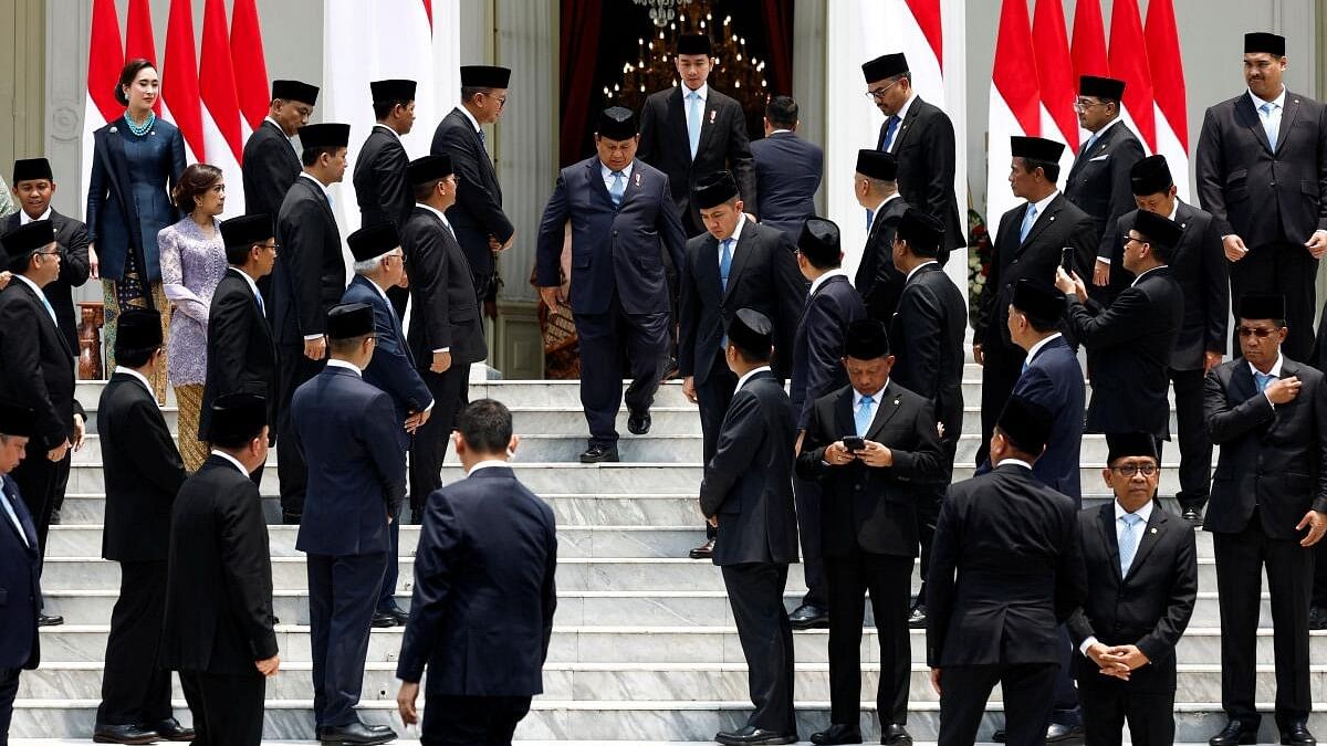 <div class="paragraphs"><p>Indonesian President Prabowo Subianto and Vice President Gibran Rakabuming Raka arrive for a group photo with newly appointed cabinet&nbsp;ministers, at the Presidential Palace in Jakarta, Indonesia, October 21, 2024.</p></div>