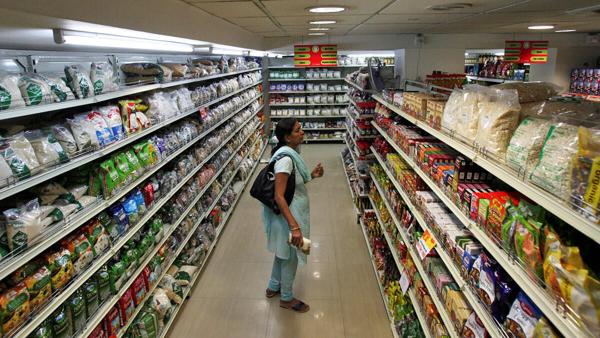 <div class="paragraphs"><p>A customer looks at consumable goods before buying them at a supermarket in Hyderabad</p></div>