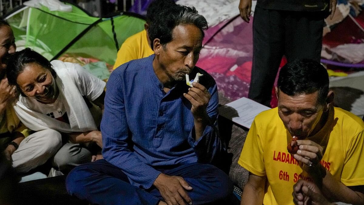 <div class="paragraphs"><p>Climate activist Sonam Wangchuk with supporters blows whistles after breaking their indefinite fast following the Union Home Ministry's letter assuring that the next meeting with Ladakh groups will be held on December 3, at Ladakh Bhawan, in New Delhi.</p></div>