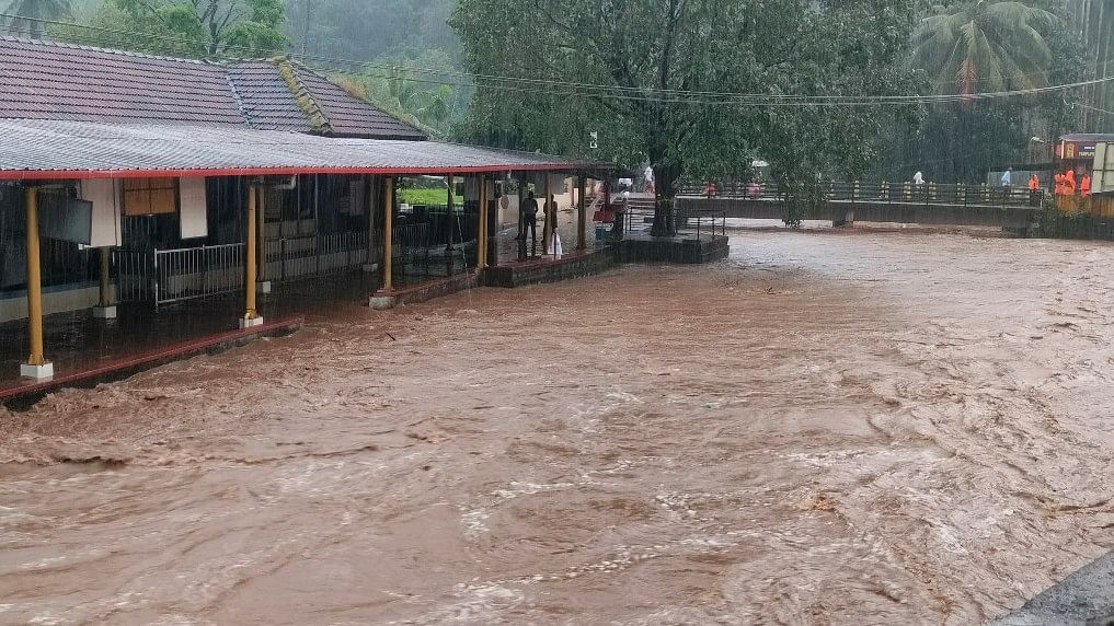 The swollen Darpan Theertha rivulet floods Adi Subrahmanya temple after a sharp spell of rain in Subrahmanya, DK district.