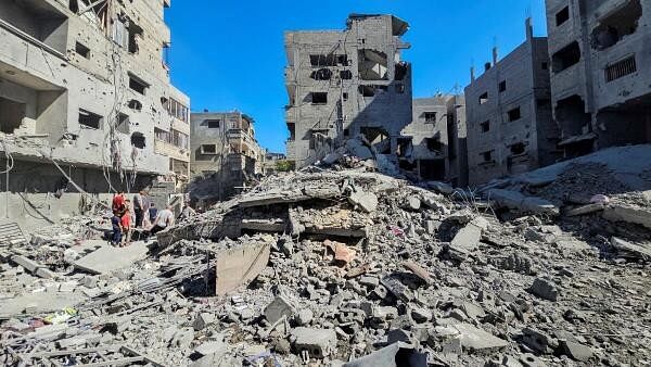 <div class="paragraphs"><p>Palestinians gather at the site of Israeli strikes on houses and residential buildings, amid the ongoing Israel-Hamas conflict, in Beit Lahiya, in the northern Gaza Strip.&nbsp;</p></div>