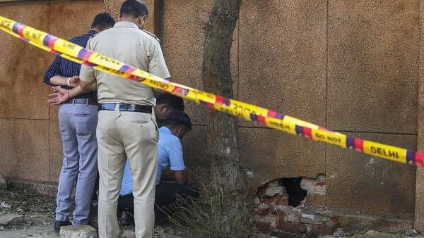 <div class="paragraphs"><p>NIA and Delhi Police officials investigate at the site where a blast occured on Sunday, near a CRPF school at Prashant Vihar, in Rohini area of New Delhi.&nbsp;</p></div>