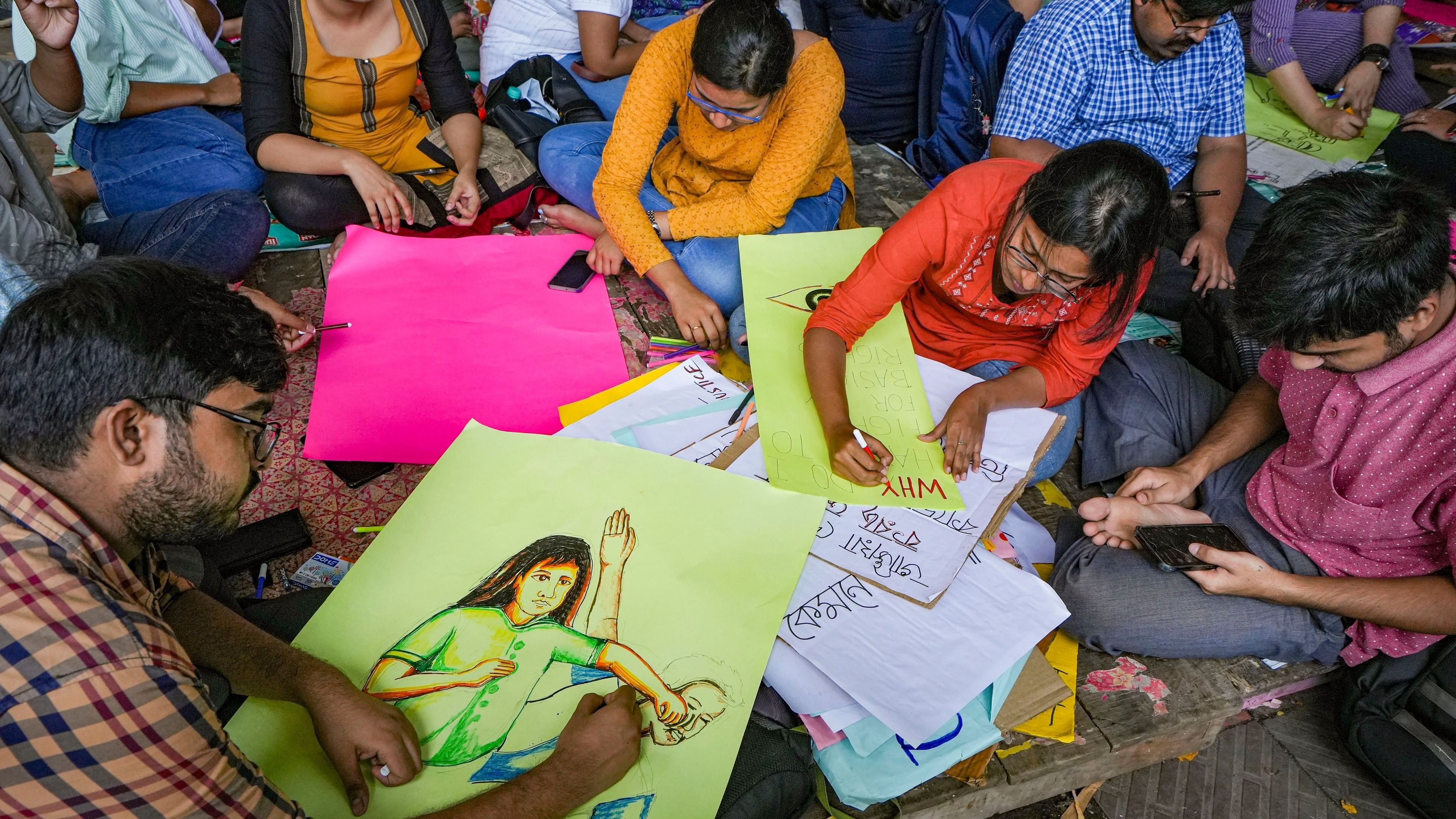 <div class="paragraphs"><p> Junior doctors prepare posters during their protest amid the 24-hours nationwide strike called by the Indian Medical Association (IMA) demanding justice for the woman doctor who was allegedly raped and murdered at R G Kar Medical College and Hospital, in Kolkata.</p></div>