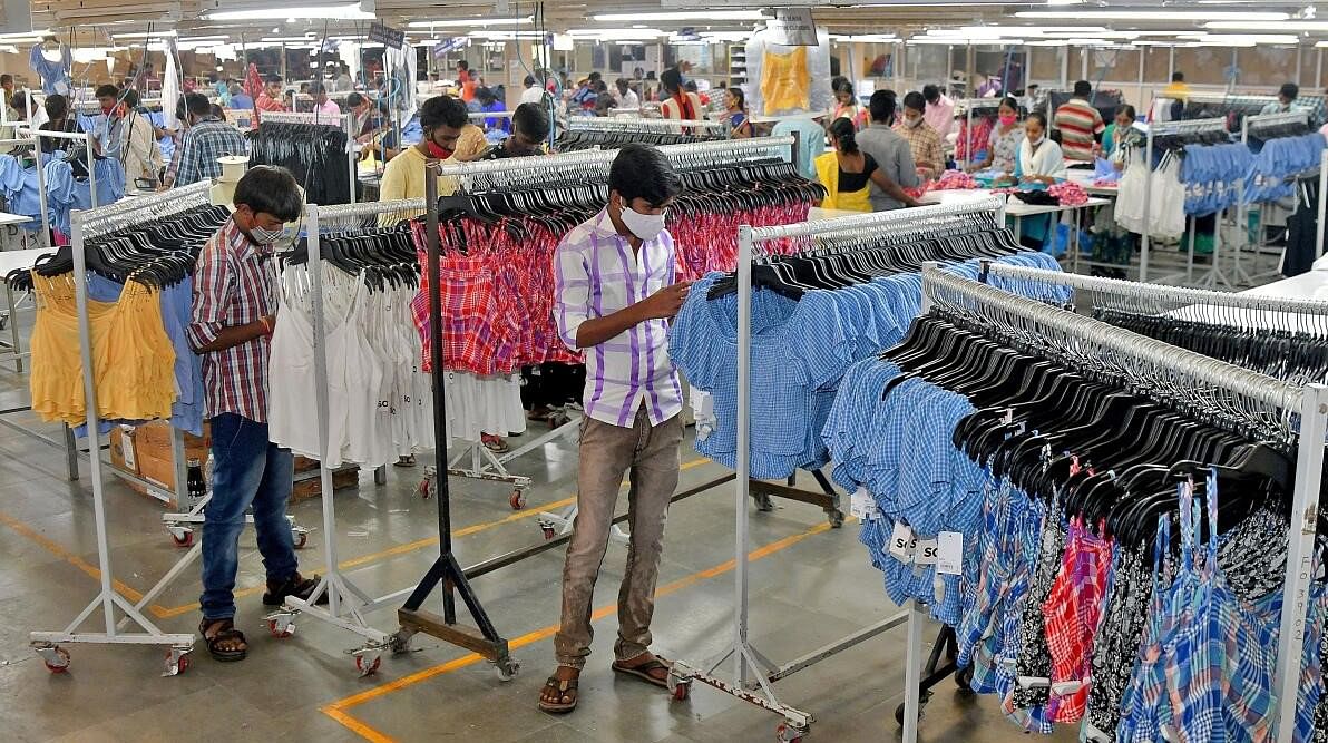 <div class="paragraphs"><p>FILE PHOTO: Workers inspect brand tags on apparel ready for packaging at a textile factory of Texport Industries in Hindupur.</p></div>