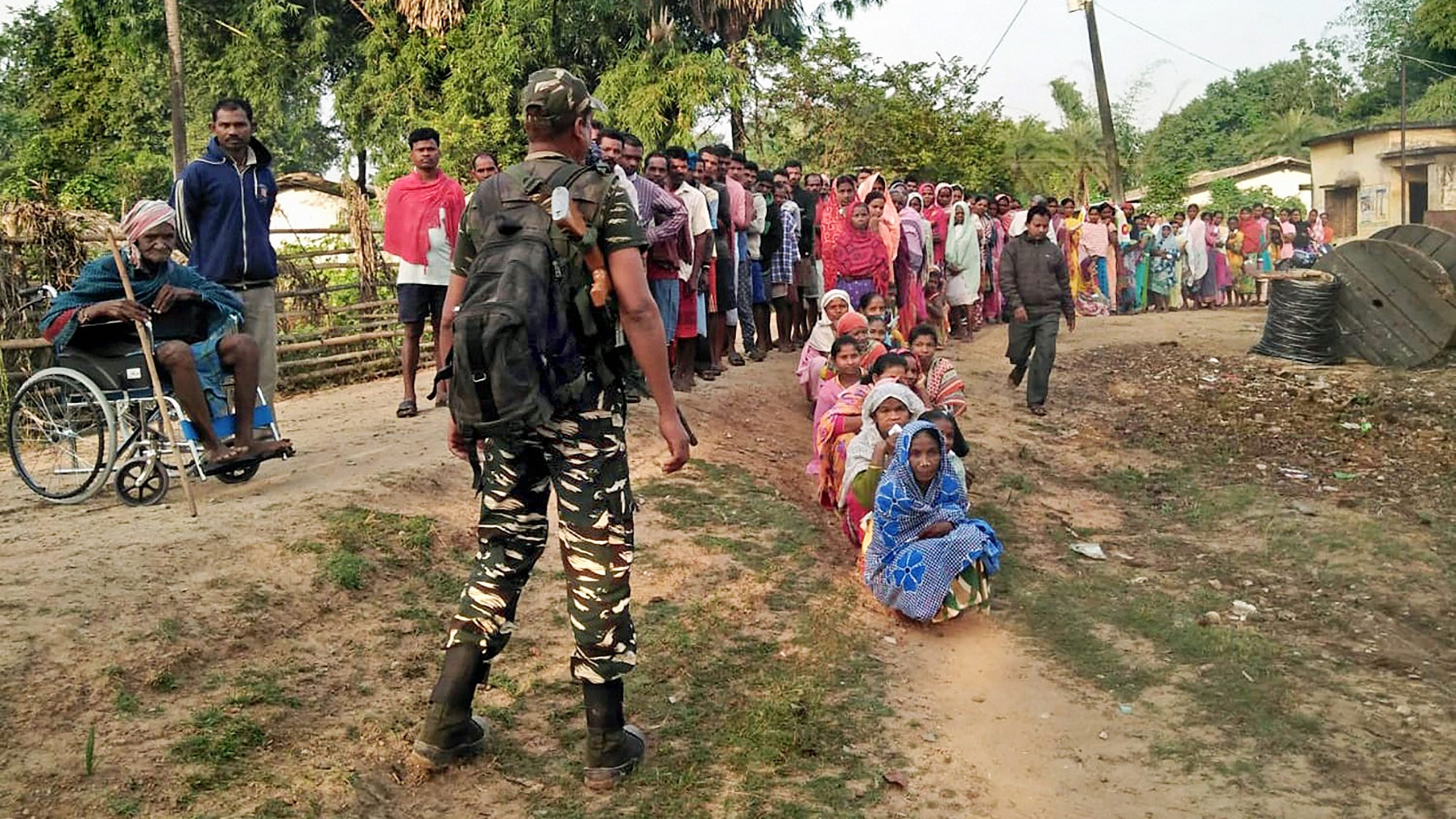 <div class="paragraphs"><p>People wait to cast their votes at a polling station  in Naxal-affected district of Jharkhand.</p></div>