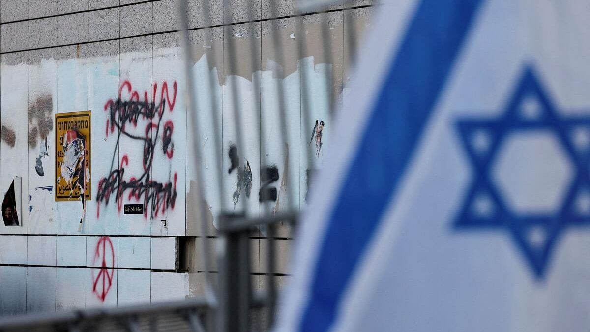 <div class="paragraphs"><p>A view shows graffiti reading, "government of terrorists", near the Israeli Ministry of Defense, in Tel Aviv, Israel.</p></div>