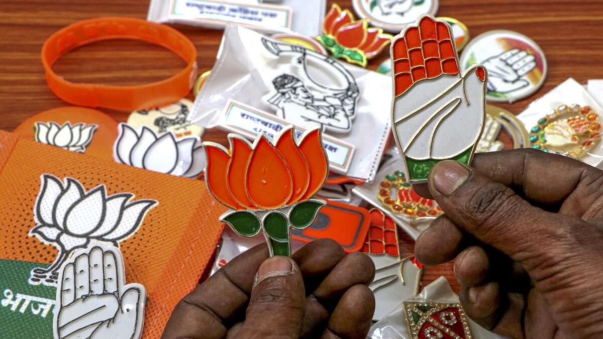 <div class="paragraphs"><p>A vendor shows political badges of BJP and Congress at a shop, ahead of Maharashtra Assembly elections, in Nagpur</p></div>