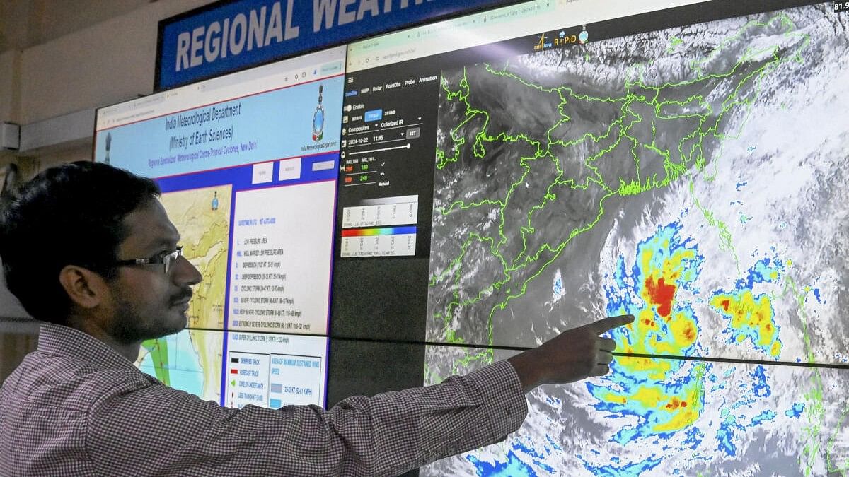 <div class="paragraphs"><p>Kolkata: Scientist Sourish Bandopadhyay shows the progress of cyclonic storm 'Dana' on a digital screen, at the regional meteorogical centre in Kolkata, Tuesday, Oct. 22, 2024.</p></div>