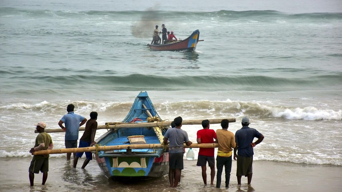 <div class="paragraphs"><p>Puri: Fishermen shift their boats in preparations for Cyclone Dana, in Puri.</p></div>