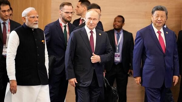 <div class="paragraphs"><p>Indian Prime Minister Narendra Modi, Russian President Vladimir Putin and Chinese President Xi Jinping attend a family photo ceremony prior to the BRICS Summit plenary session in Kazan, Russia.</p></div>