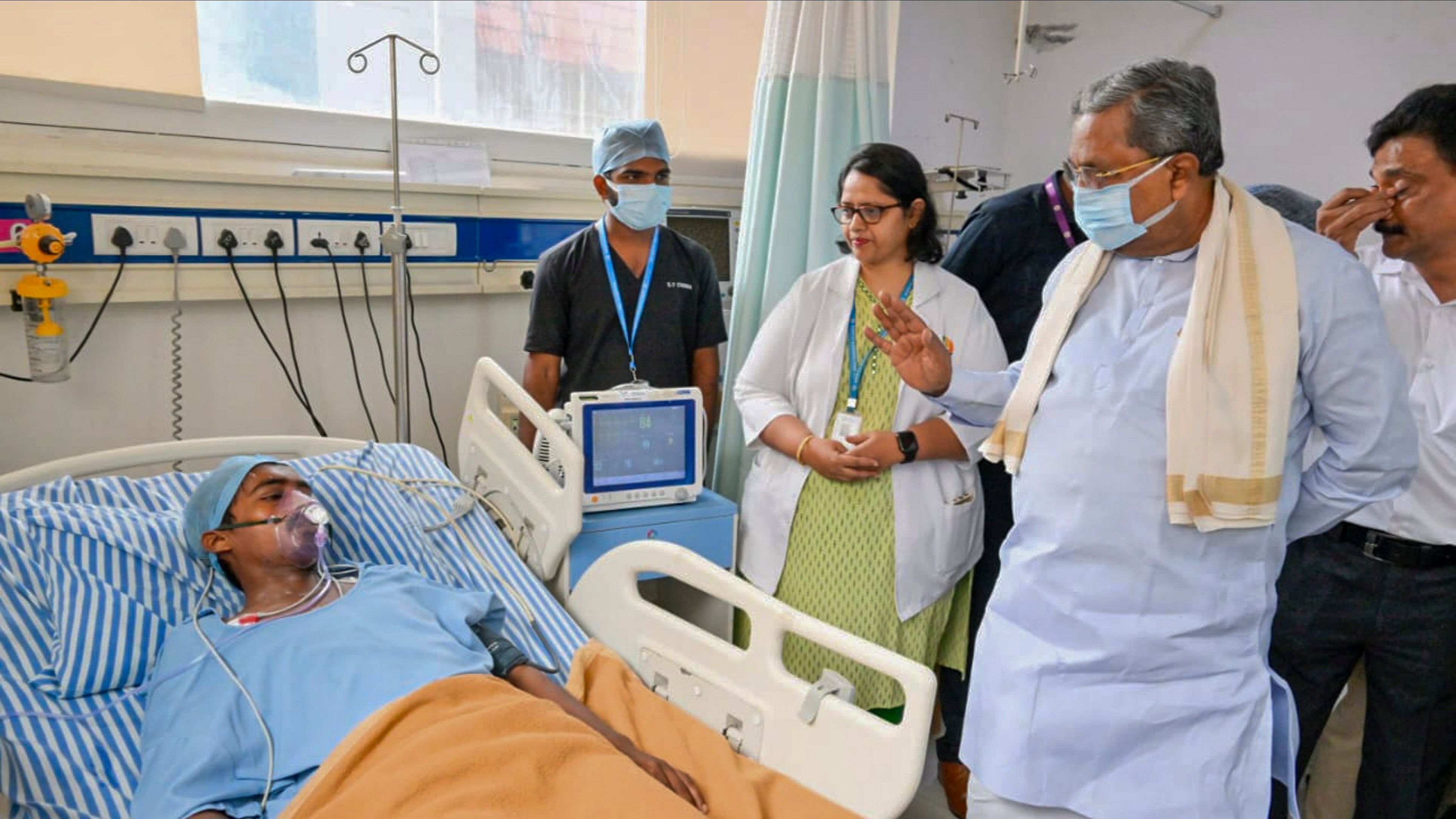 <div class="paragraphs"><p>Bengaluru: Karnataka Chief Minister Siddaramaiah interacts with a person undergoing treatment after getting injured in the recent under-construction building collapse, in Bengaluru.</p></div>