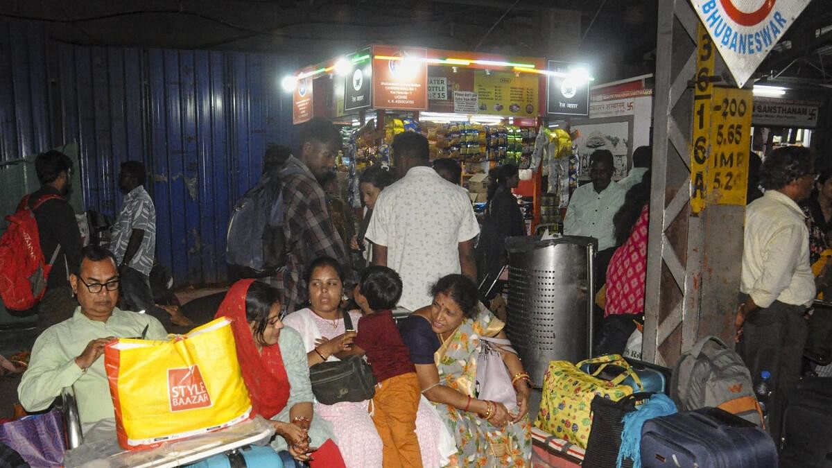 <div class="paragraphs"><p>Passengers wait at Bhubaneswar railway station after several trains were cancelled as part of safety measures in view of Cyclone Dana.&nbsp;</p></div>