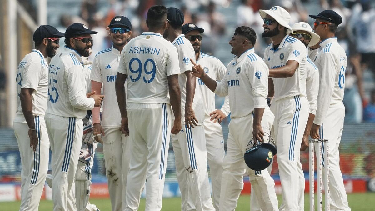 <div class="paragraphs"><p>India's Ravichandran Ashwin celebrates with teammates after a successful DRS review for the wicket of New Zealand’s Will Young on the first day of the second test cricket match between India and New Zealand, at the Maharashtra Cricket Association Stadium, in Pune, Thursday, Oct. 24, 2024. </p></div>