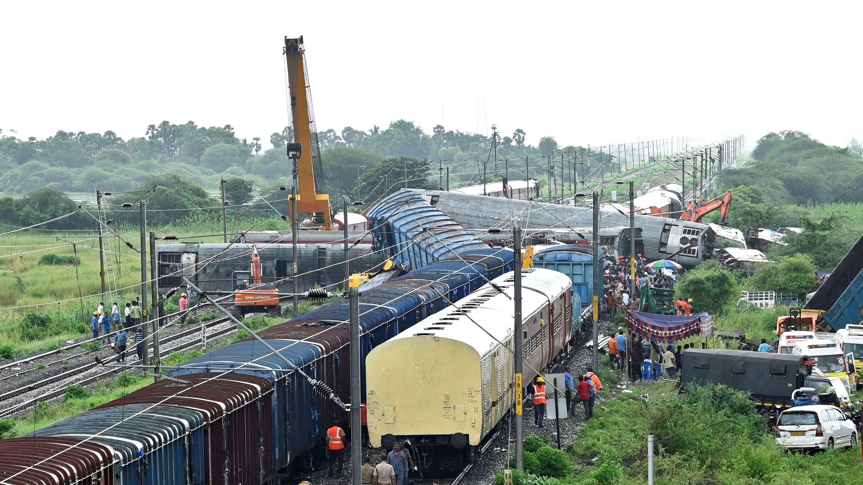 <div class="paragraphs"><p>Police and railway officials work next to damaged coaches after a passenger train collided with a stationary goods train at the Kavaraipettai railway station in the southern state of Tamil Nadu, India, October 12, 2024.</p></div>