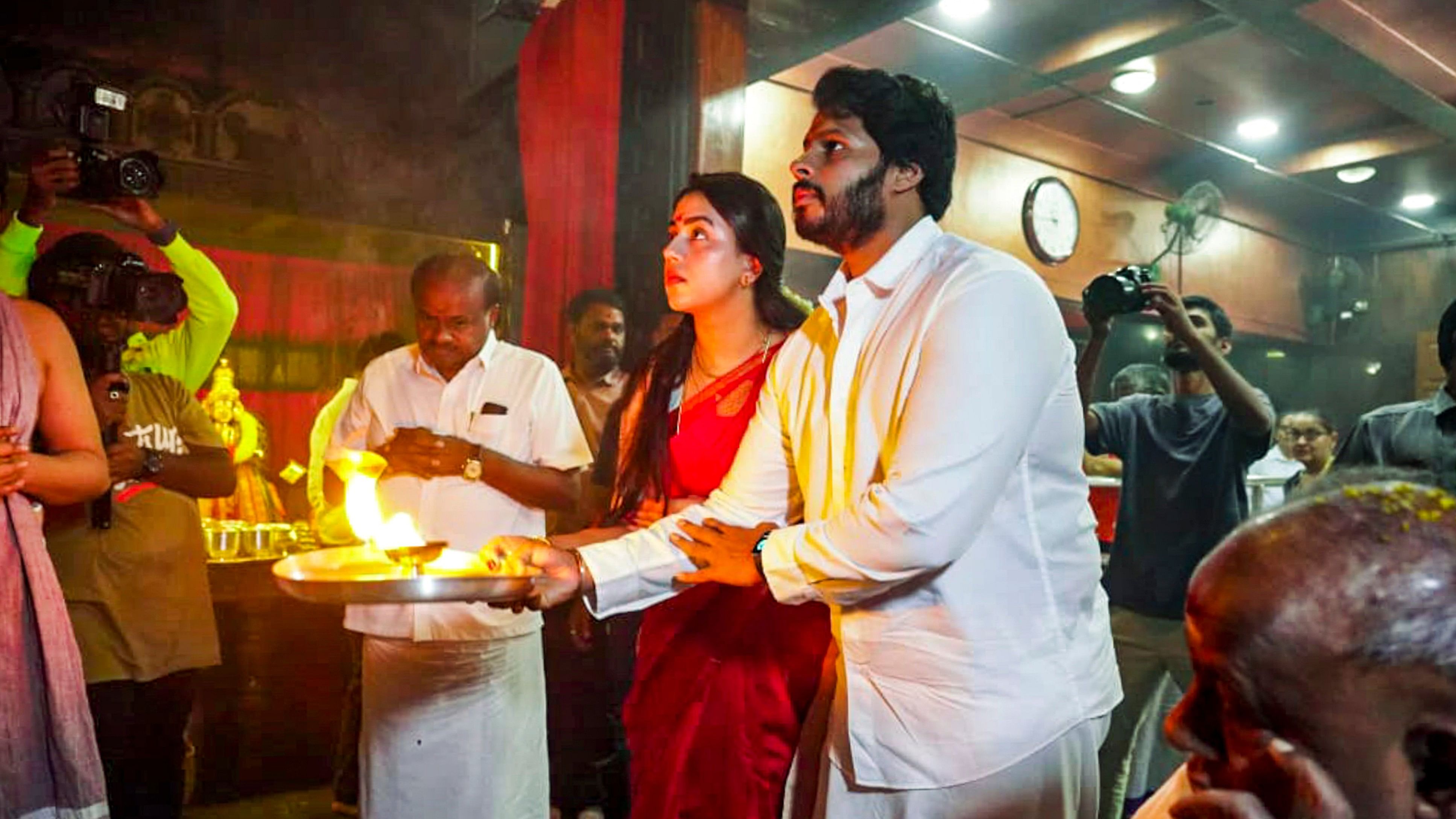 <div class="paragraphs"><p>NDA candidate for Channapatna Assembly constituency bypoll Nikhil Kumaraswamy along with his wife offers prayers at a temple, in Channapatna, Karnataka, Friday, Oct 25, 2024. </p></div>