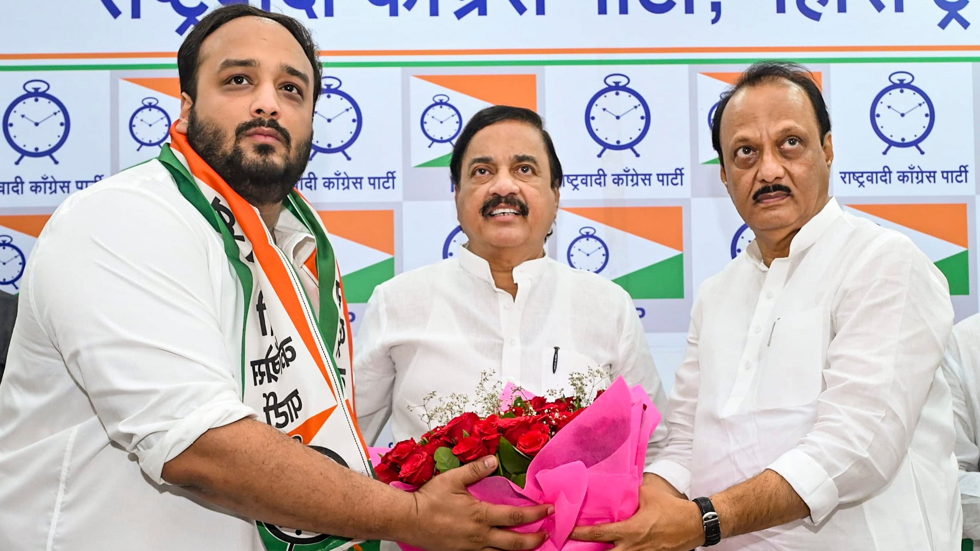 <div class="paragraphs"><p>Maharashtra Deputy Chief Minister and NCP (Ajit) chief Ajit Pawar (R) felicitates Zeeshan Siddique (L) as the latter joins the party and will contest from the Bandra East constituency in the upcoming Maharashtra Assembly elections, in Mumbai.</p></div>