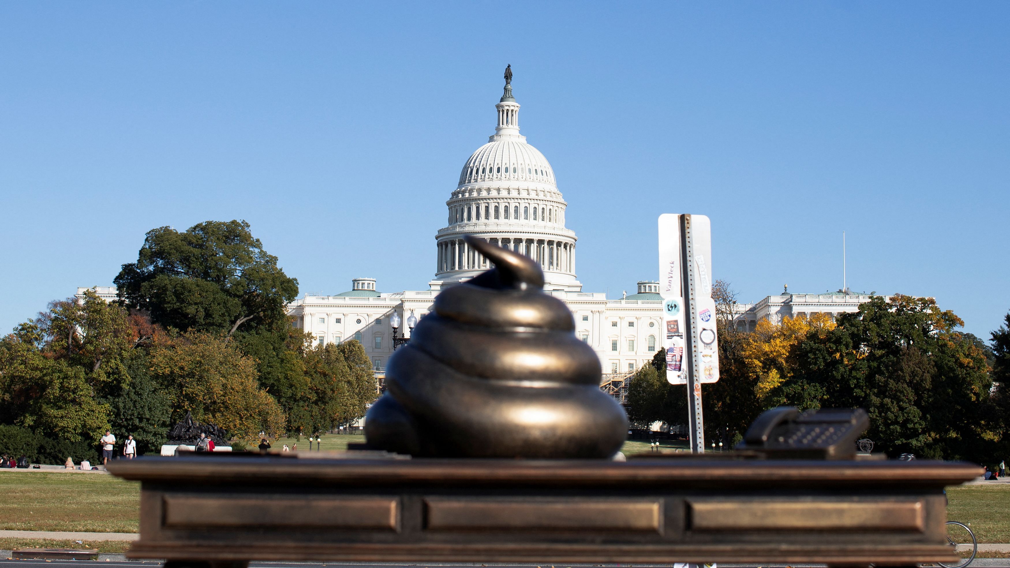 <div class="paragraphs"><p>A new temporary statue of a brass-colored desk with a large poop-shaped emoji on top of it, referencing those who attacked the U.S. Capitol on January 6, 2021, is seen near the Capitol in Washington, US.</p></div>