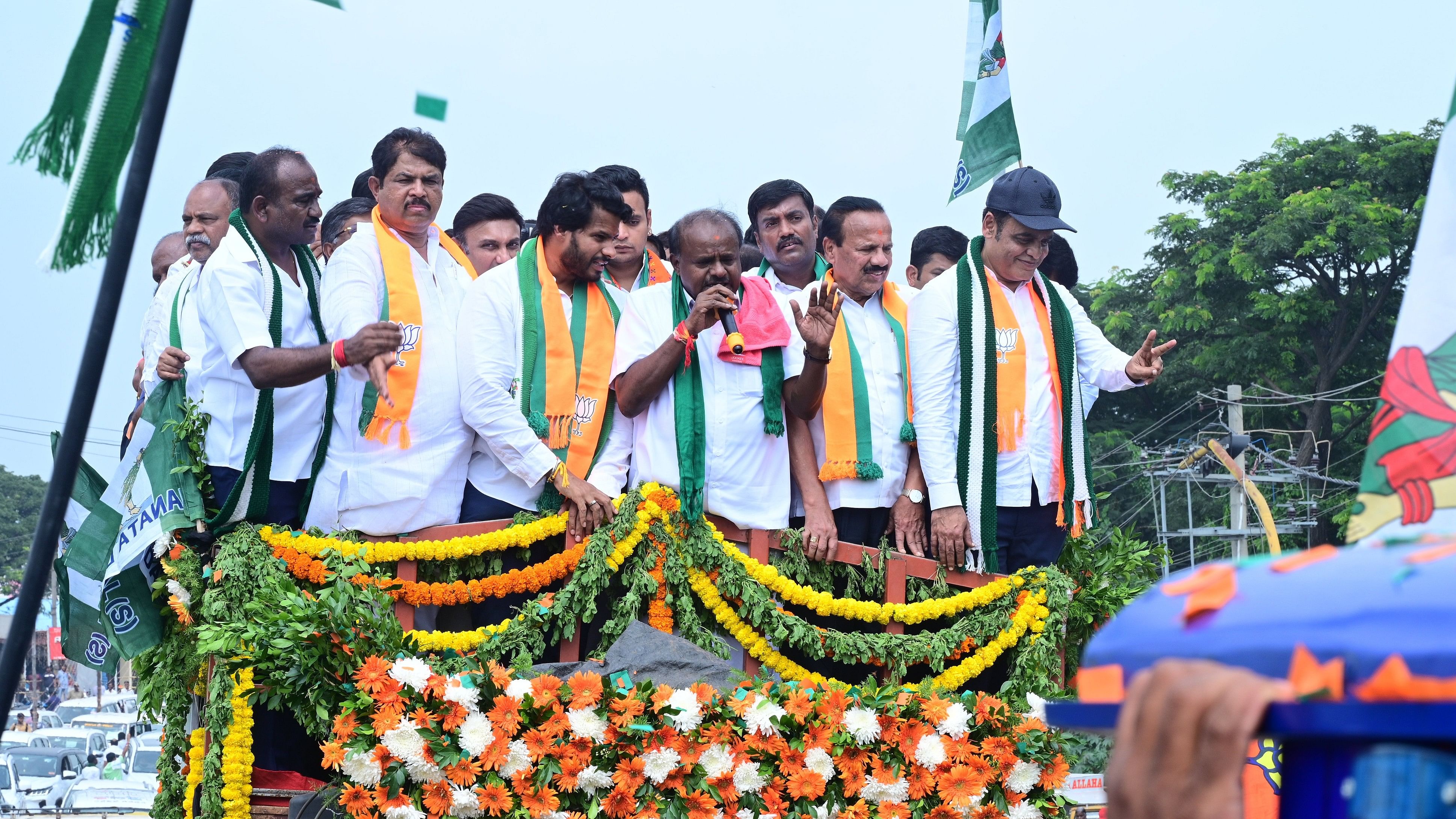 <div class="paragraphs"><p>Union Minister H D Kumaraswamy speaks at a roadshow taken out before NDA candidate Nikhil Kumaraswamy filed his nomination paper for the by-election in Channapatna on Friday. Nikhil, BJP leaders R Ashoka, D V Sadananda Gowda and C N Ashwath Narayan are seen.</p></div>