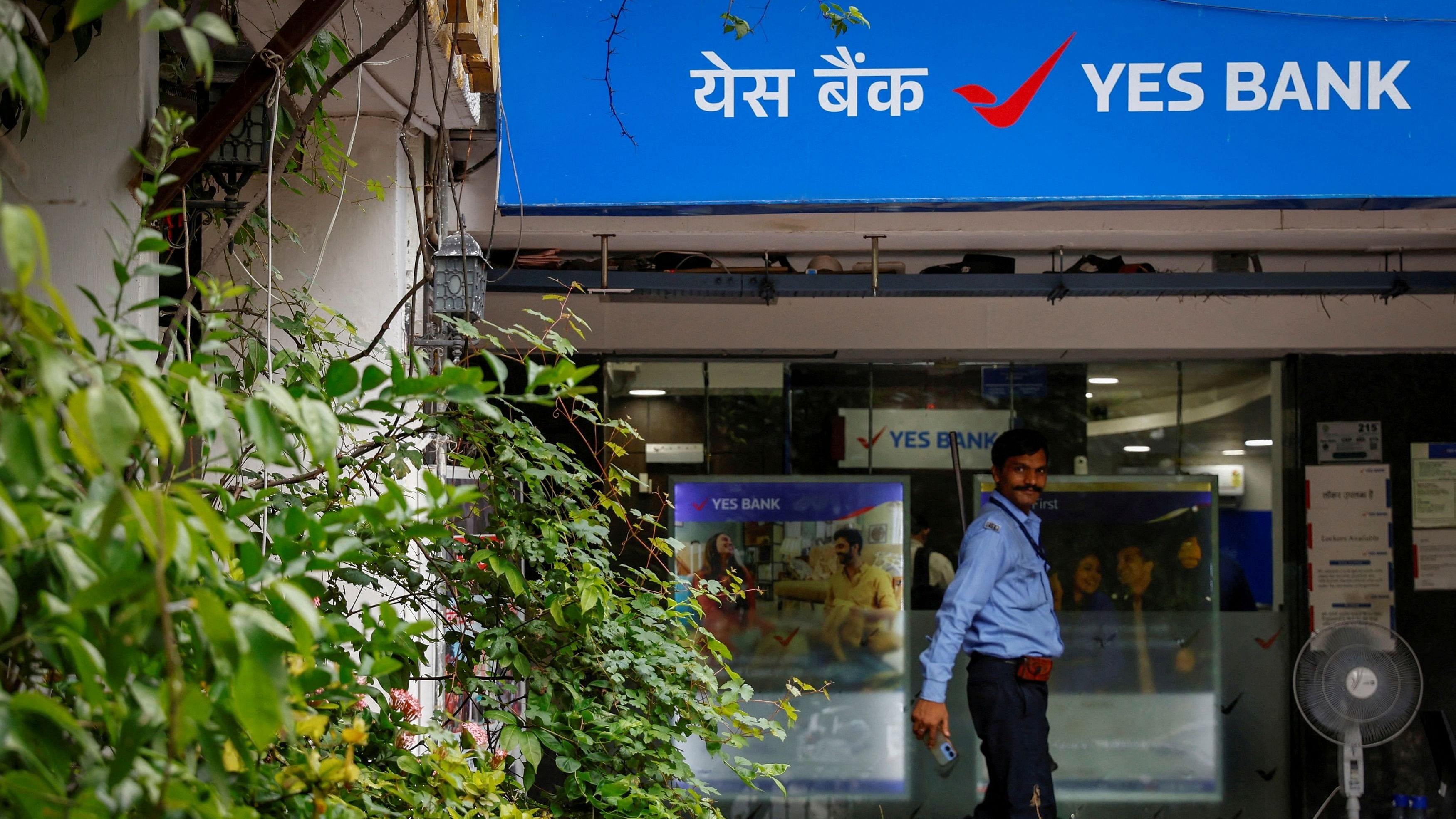 <div class="paragraphs"><p>A private security guard stands outside a branch of Yes Bank in New Delhi.</p></div>