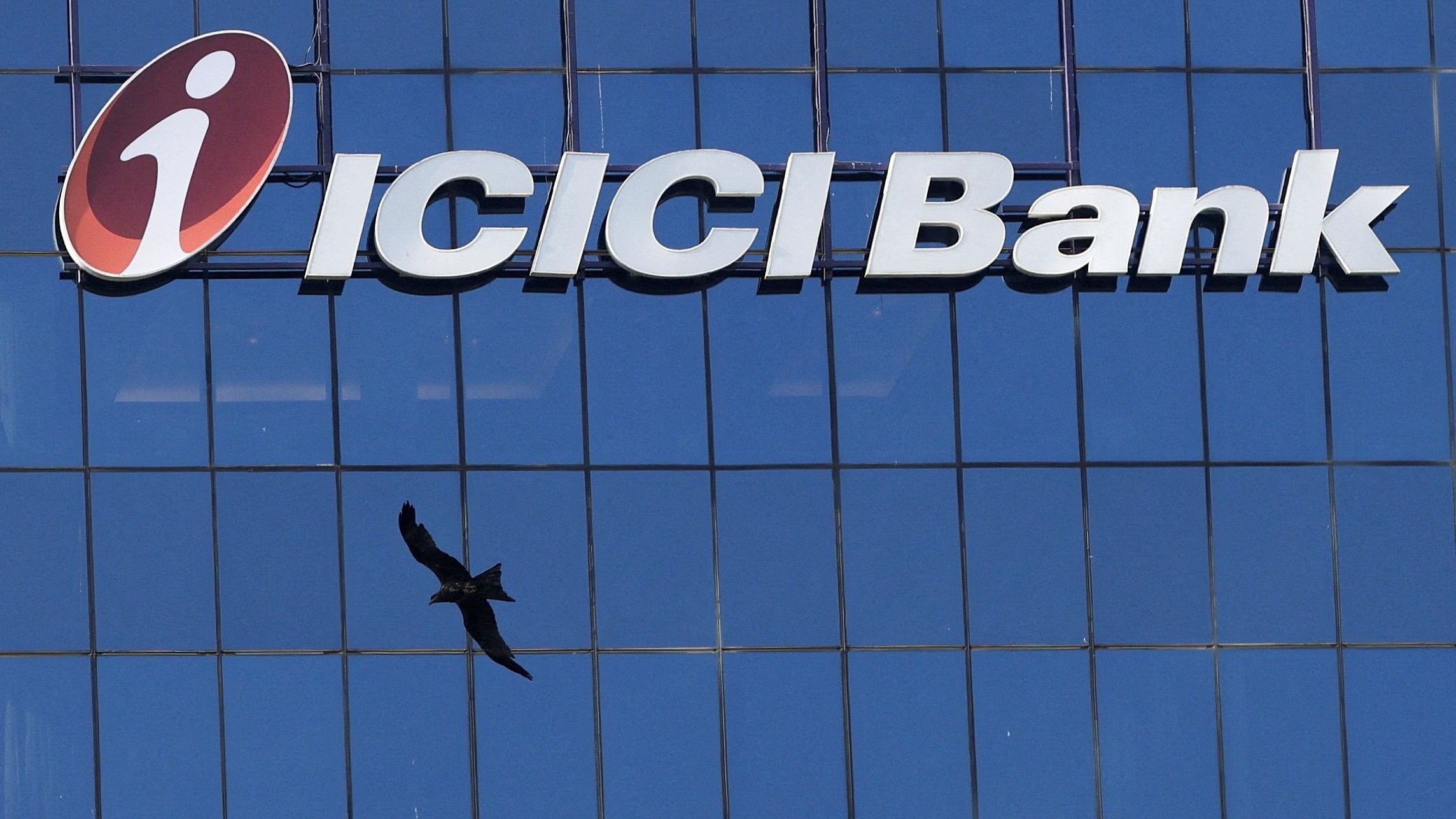 <div class="paragraphs"><p>A bird flies past the facade of the ICICI bank head office in Mumbai.</p></div>