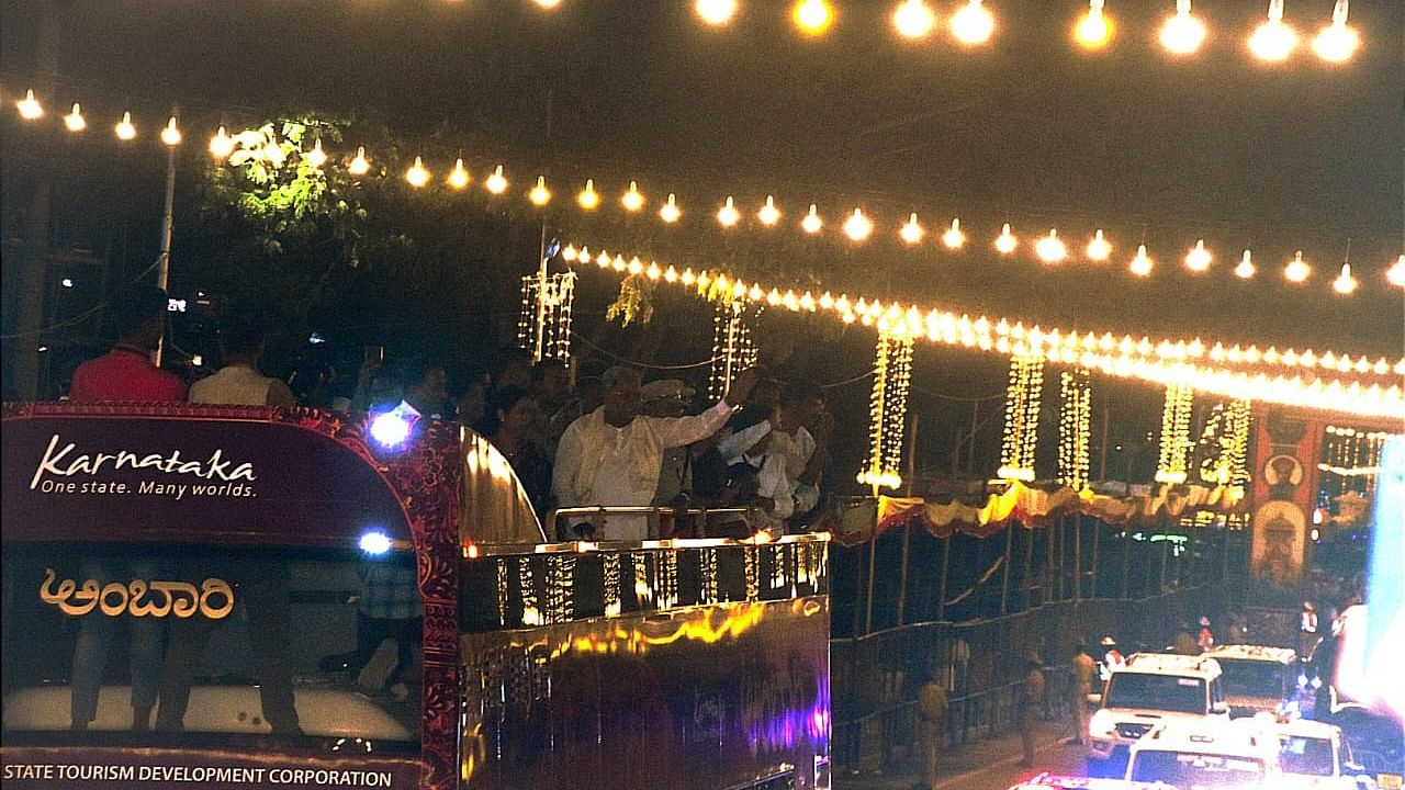 <div class="paragraphs"><p>Chief Minister Siddaramaiah enjoys Mysuru city illumination atop Ambaari bus during Dasara, on October 11.</p></div>