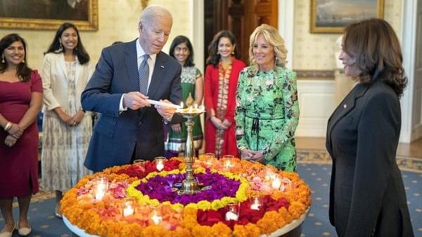 <div class="paragraphs"><p>File Photo: United States President Joe Biden lights a lamp as First lady Jill Biden and Vice President Kamala Harris look on during an event to celebrate Diwali, at the White House in Washington in 2022</p></div>