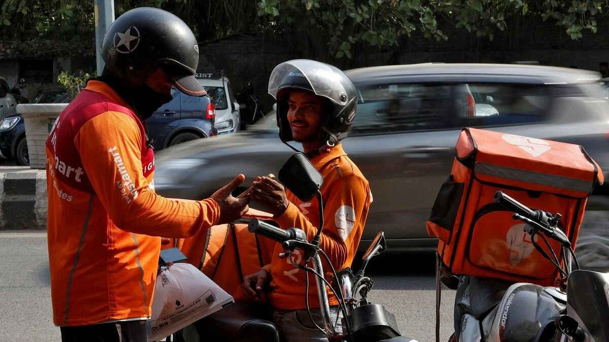 <div class="paragraphs"><p>Gig workers prepare to deliver orders outside Swiggy's grocery warehouse</p></div>