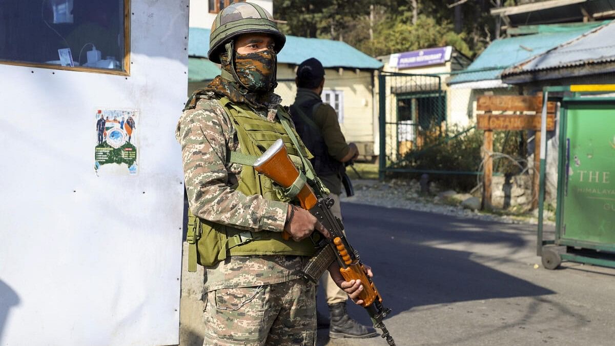 <div class="paragraphs"><p>Security personnel stand guard on the Gulmarg-Botapathri road during a search operation following a terror attack on an army vehicle</p></div>