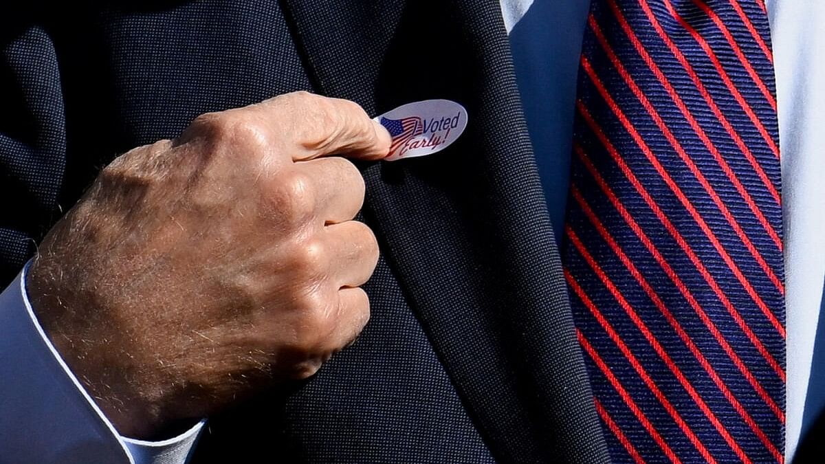 <div class="paragraphs"><p>Joe Biden points to an "I voted early" sticker on his lapel after voting in the 2024 presidential election in New Castle.&nbsp;</p></div>