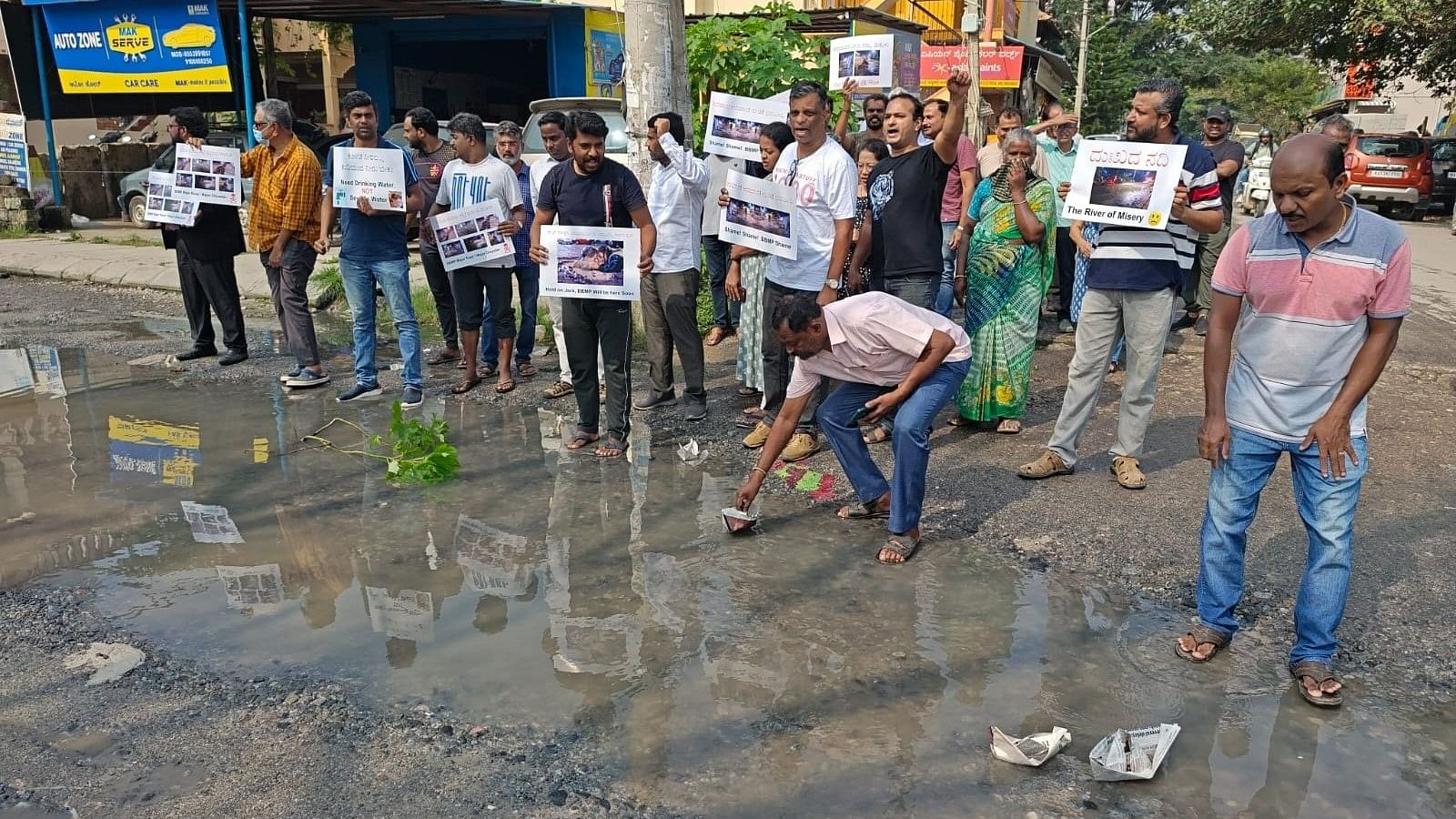 Prakruthi Township residents protest pothole-ridden roads in Bengaluru on Monday. 