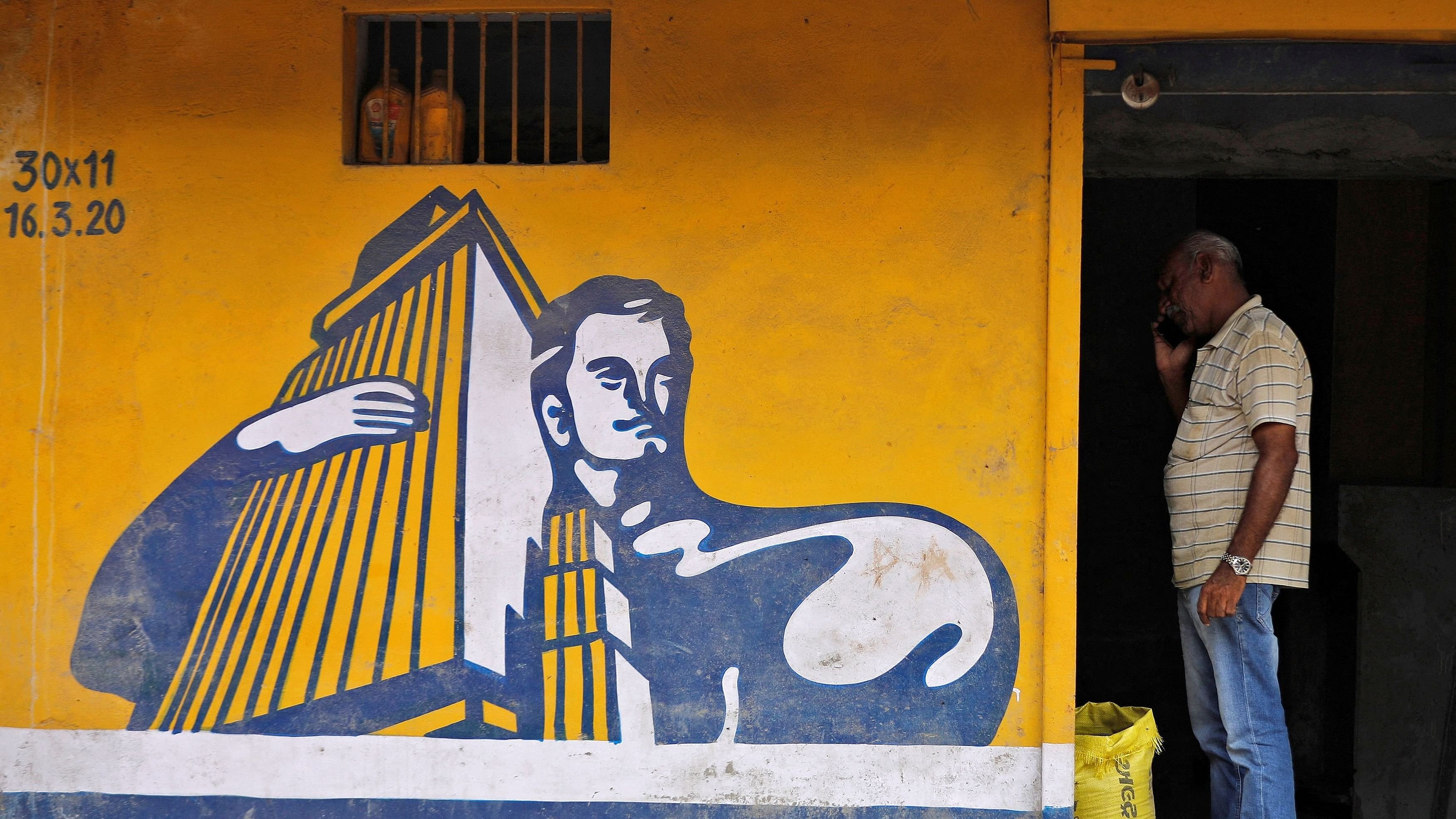 <div class="paragraphs"><p>A dealer selling Ambuja cement speaks on his phone at his shop in Ahmedabad, India, July 28, 2022. </p></div>