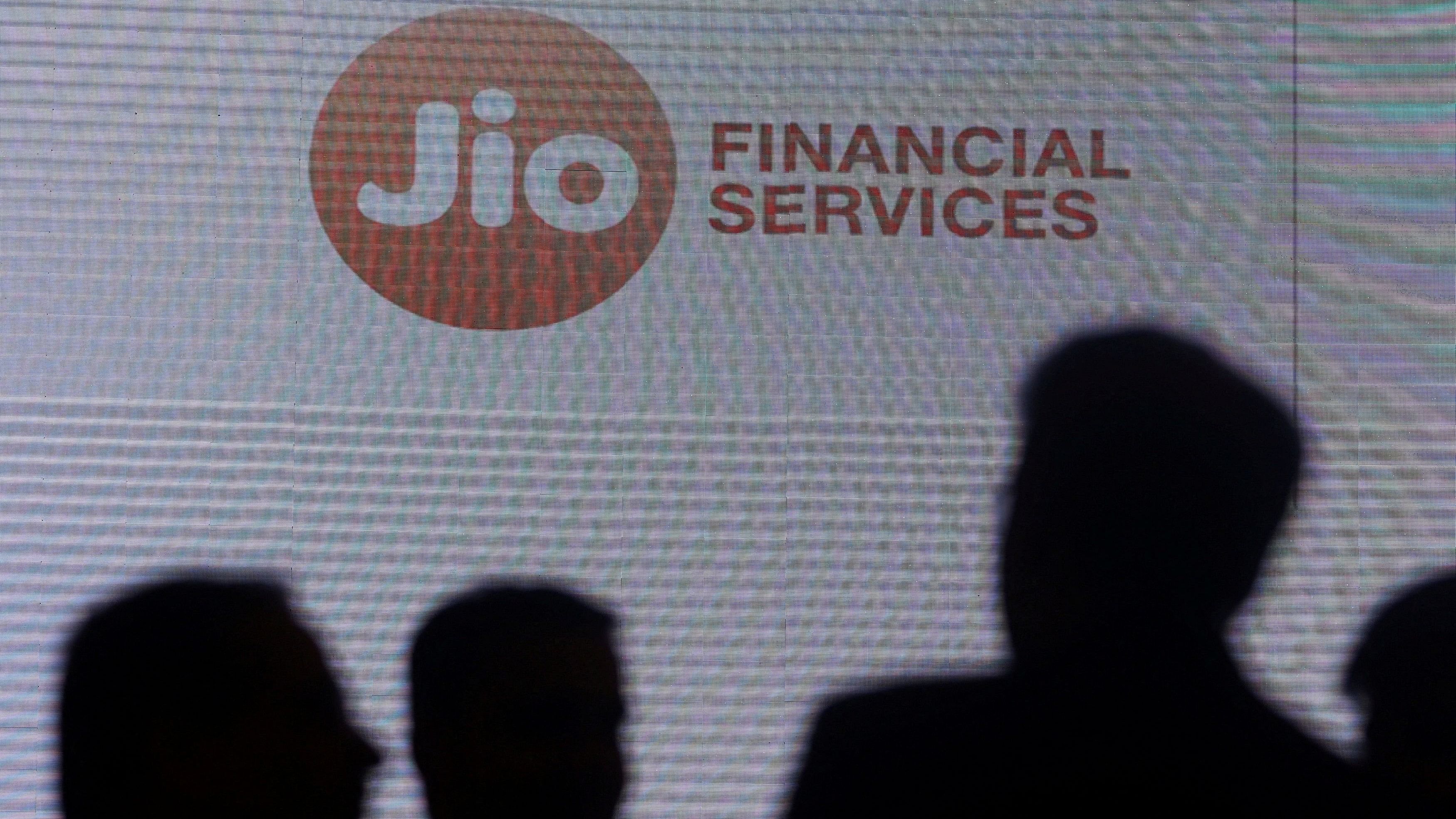 <div class="paragraphs"><p> People stand next to a logo of Jio Financial Services. (Representative image)</p></div>