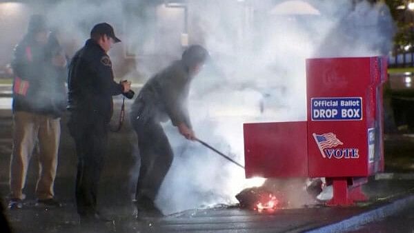 <div class="paragraphs"><p>First responders pull out the burning contents of a ballot box, used to collect early votes ahead of the Nov. 5 U.S. election, after it was set on fire in a suspected arson in Vancouver, Washington.&nbsp;</p></div>