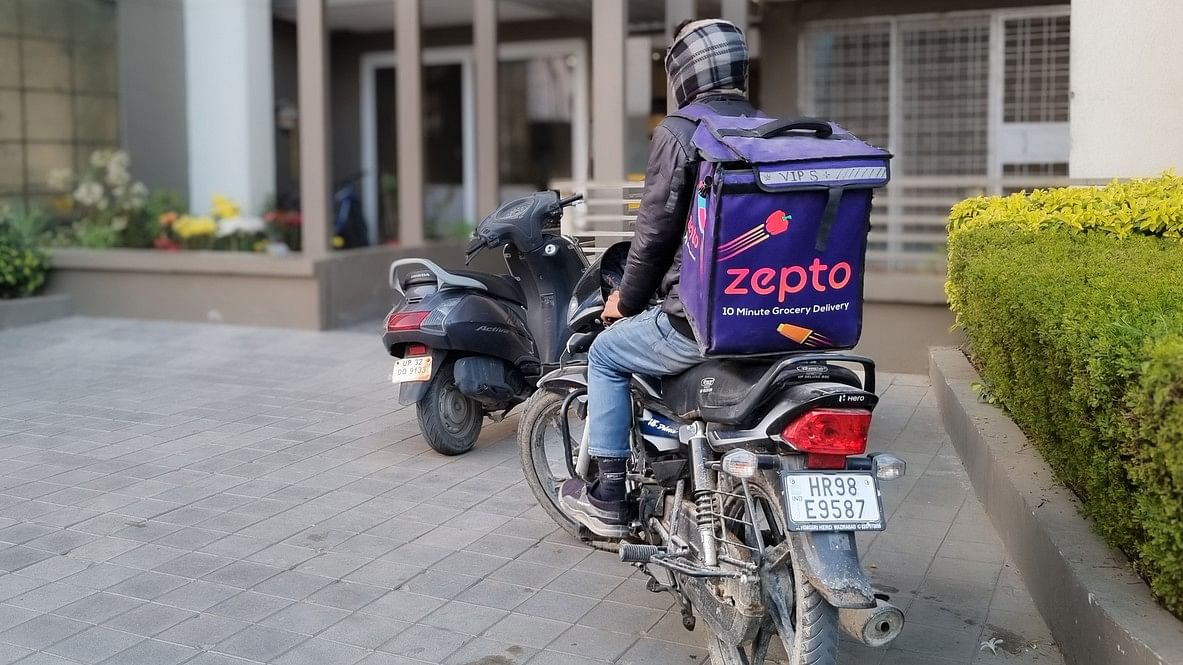 <div class="paragraphs"><p>Rider delivery boy from hyperlocal quick fast delivery app zepto standing outside a residential building showing the rapid rise of this startup.</p></div>