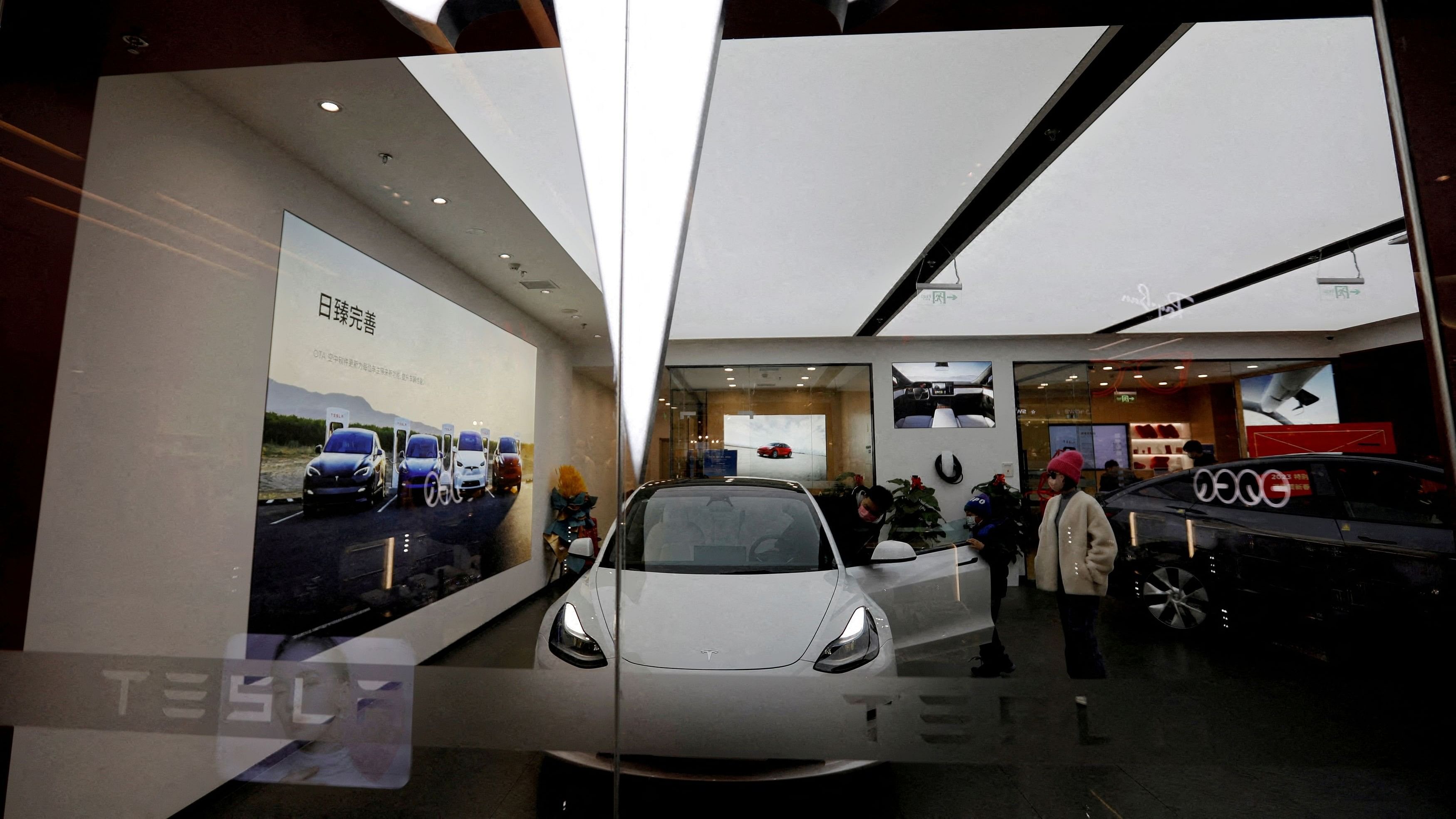 <div class="paragraphs"><p>FILE PHOTO: Visitors check a Tesla Model 3 car next to a Model Y displayed at a showroom of the US electric vehicle  maker in Beijing, China on February 4, 2023. </p></div>