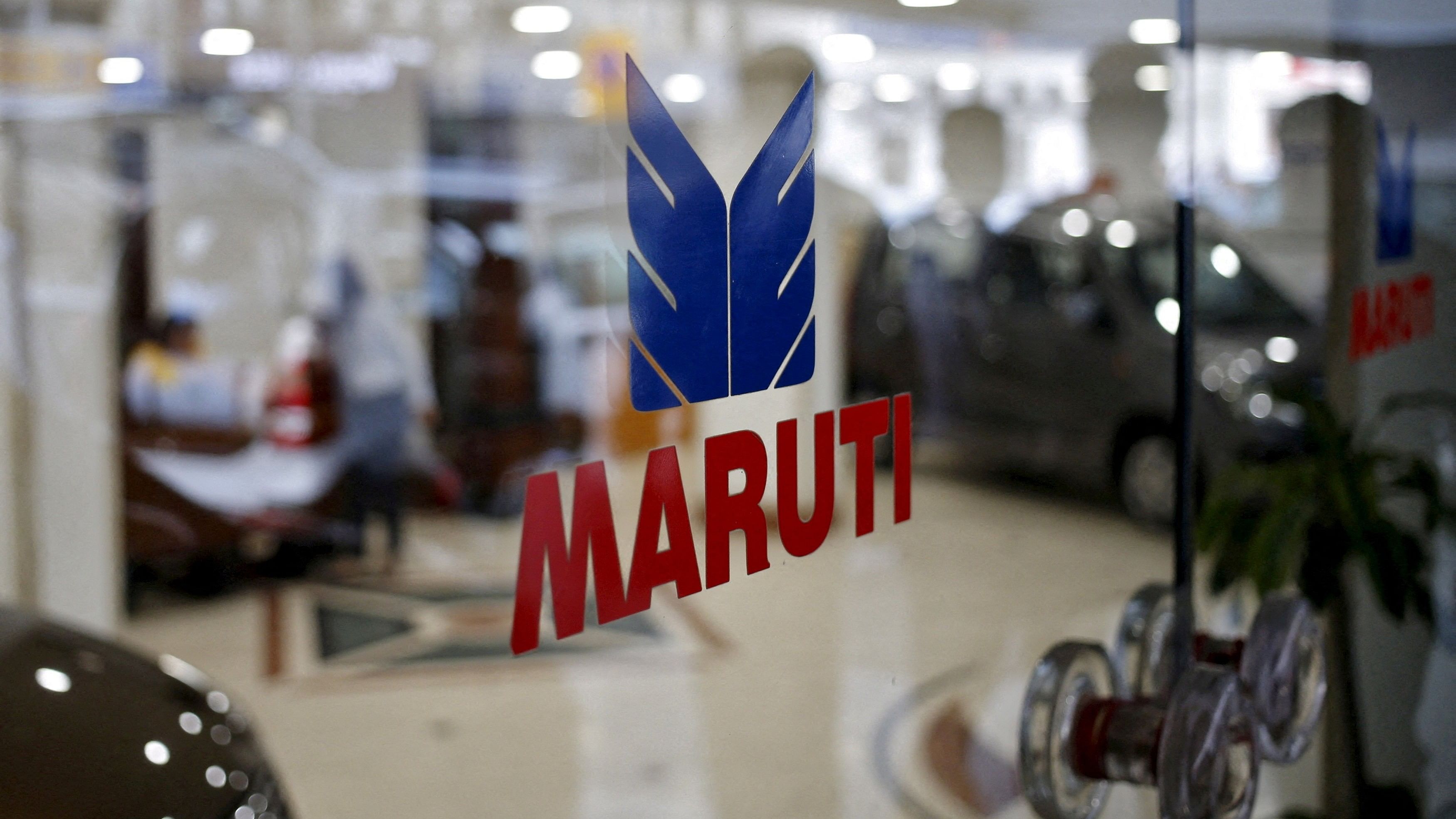 <div class="paragraphs"><p>FILE PHOTO: The logo of Maruti Suzuki India Limited is seen on a glass door at a showroom in New Delhi.</p></div>